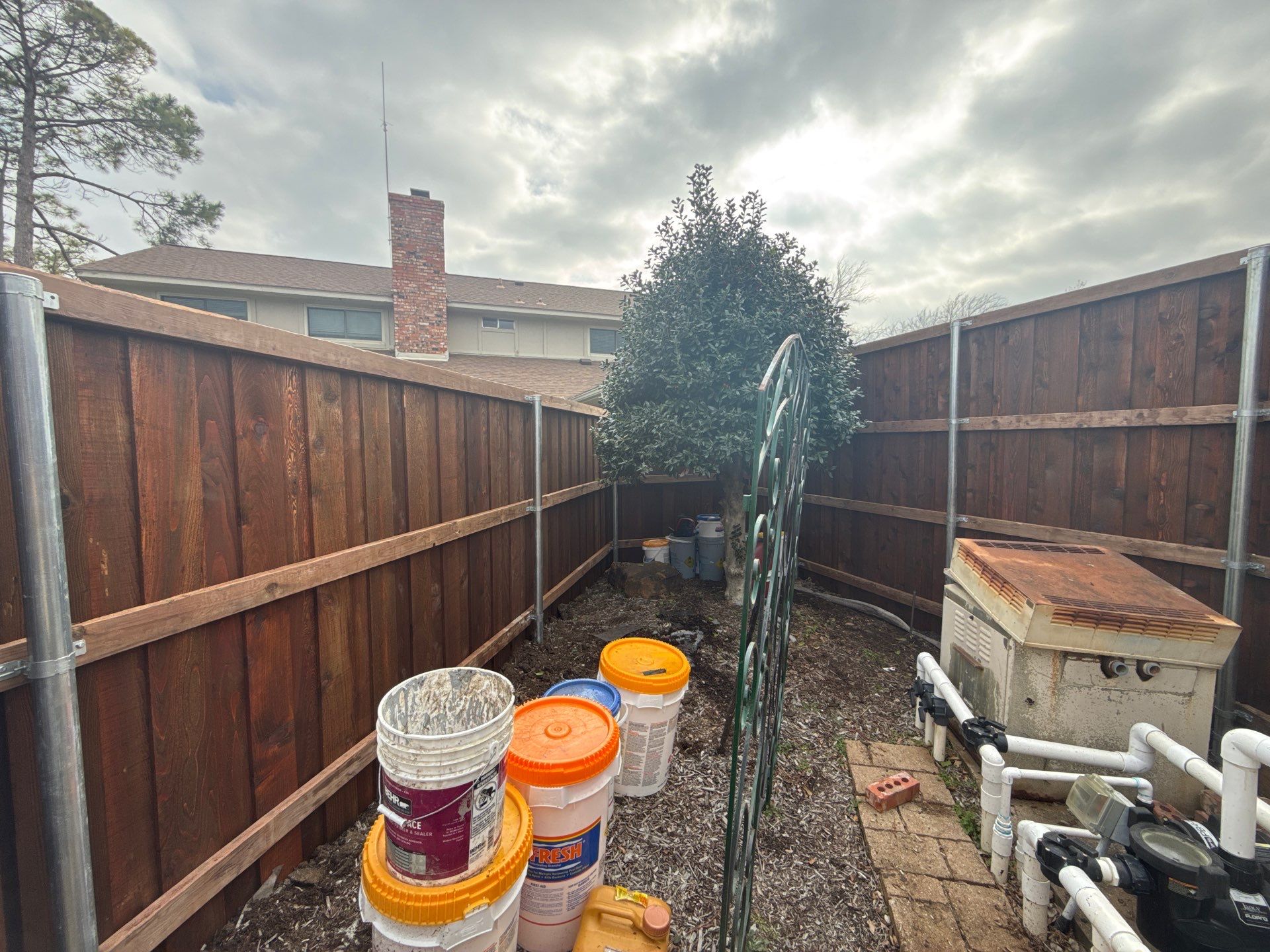 Pre-Stained board on board w/ trim and kickboard using 1x4 cedar trim by Grizzly Fence And Patio