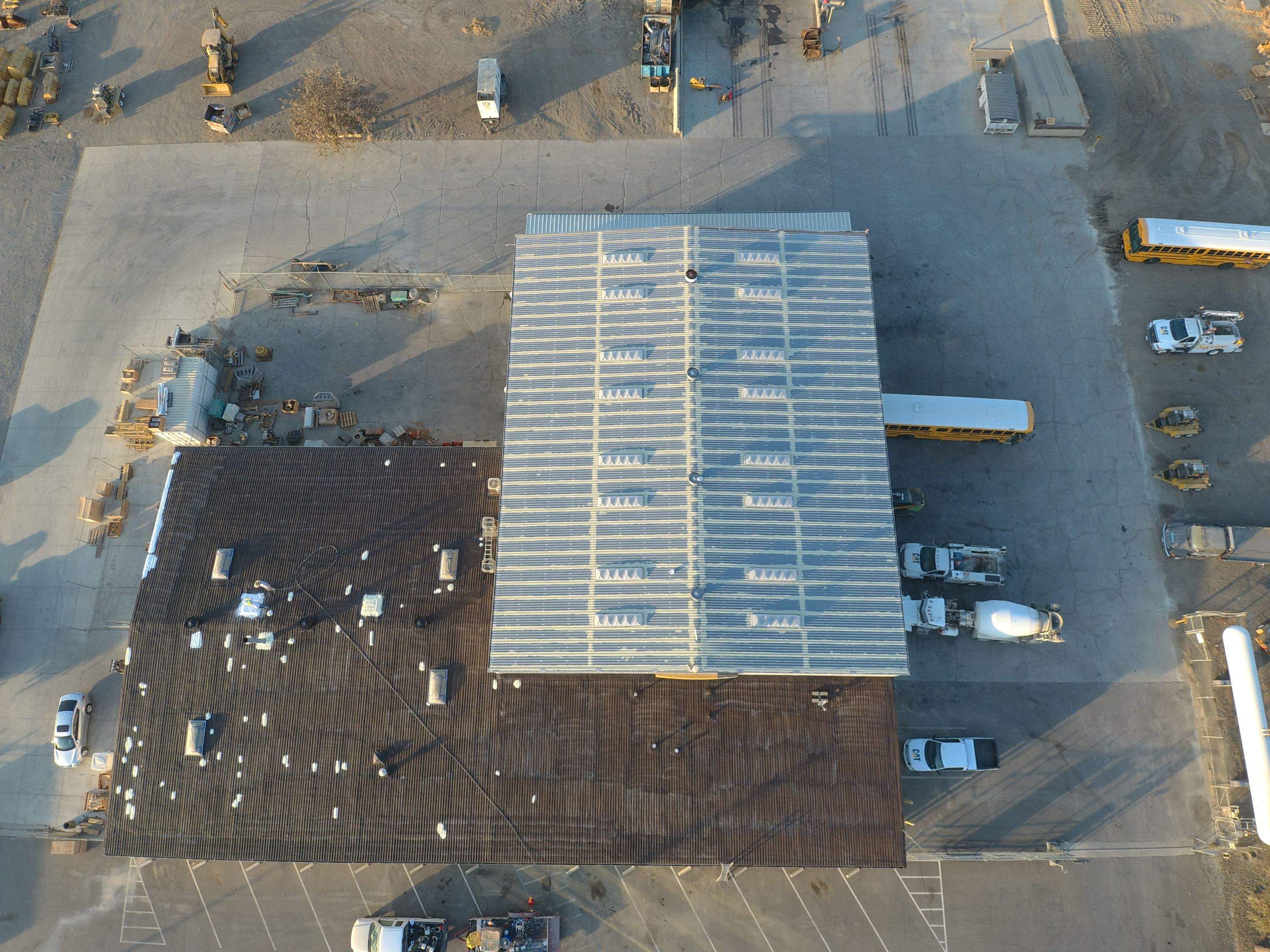 Metal roof restoration on commercial roof using Conklin Benchmark/ PUMA XL acrylic coatings over metal and foam by Straight Edge Roofing Inc