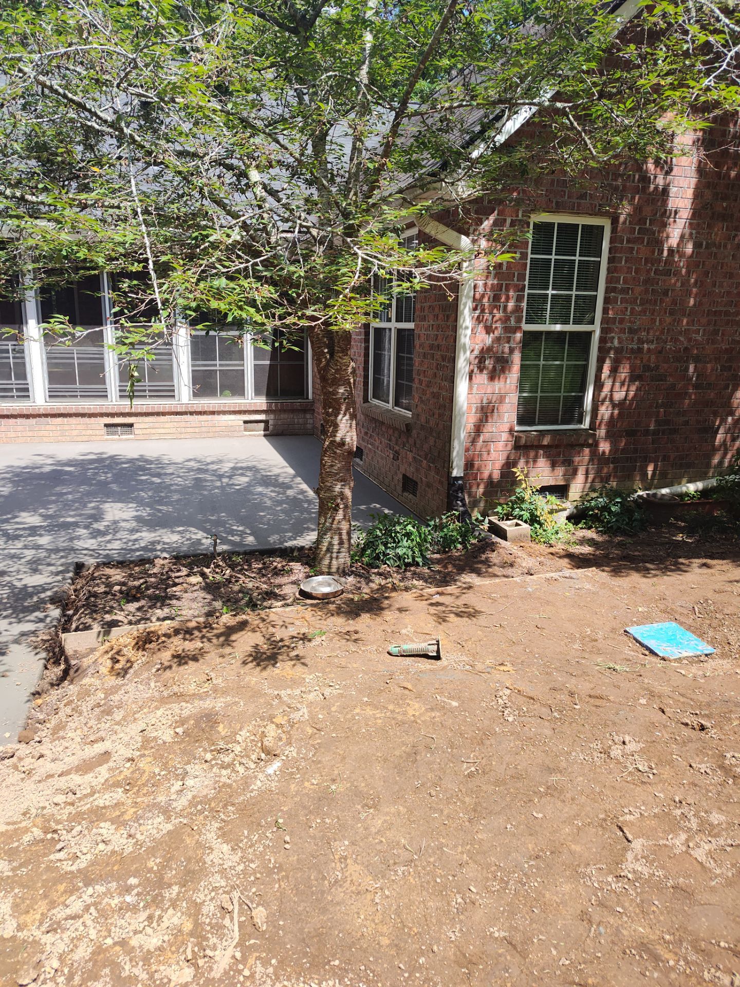 Patio in concrete with drainage improvements by Cornerstone Home Builders, LLC