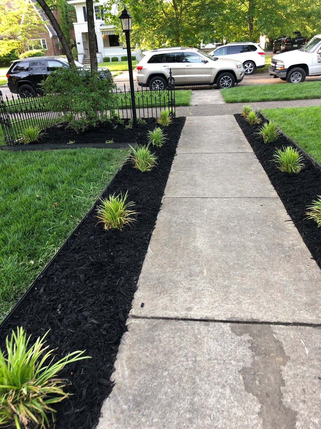 Liriope grasses, mulch and stone pavers by GrassBusters, Inc.
