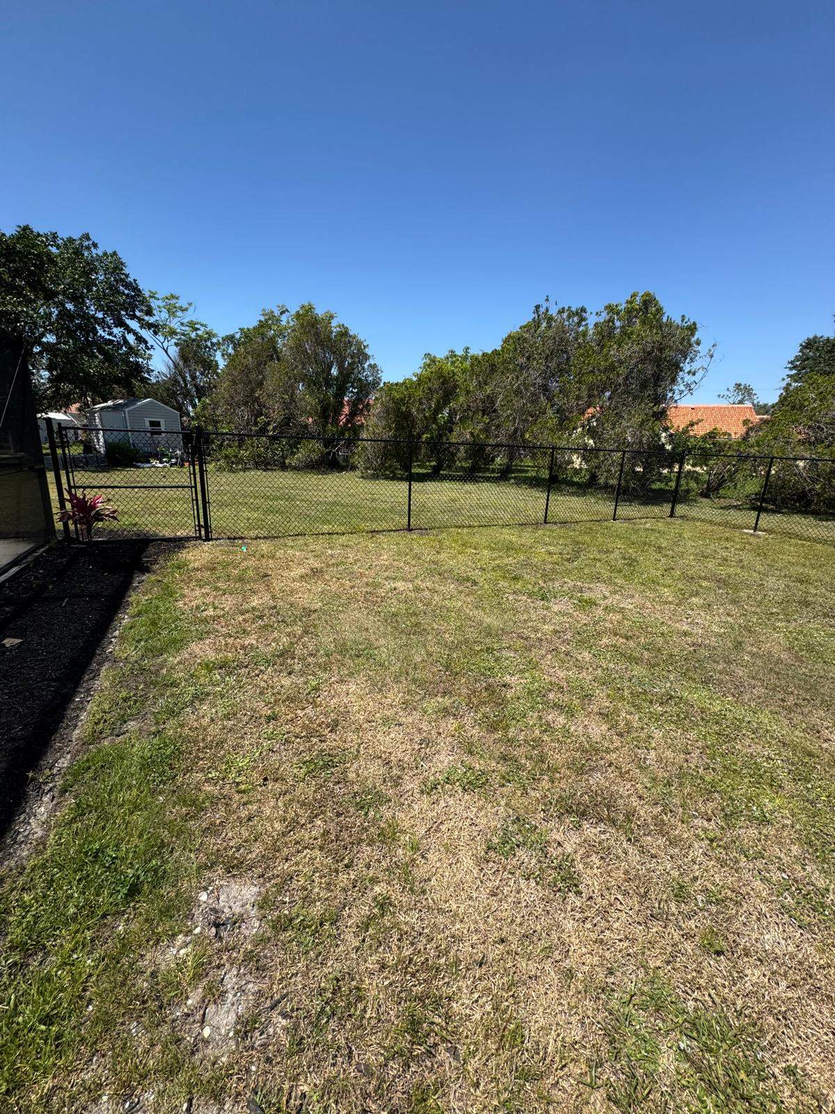 Black Chain Link Residential Backyard Fence Installation in North Port by True Fence LLC