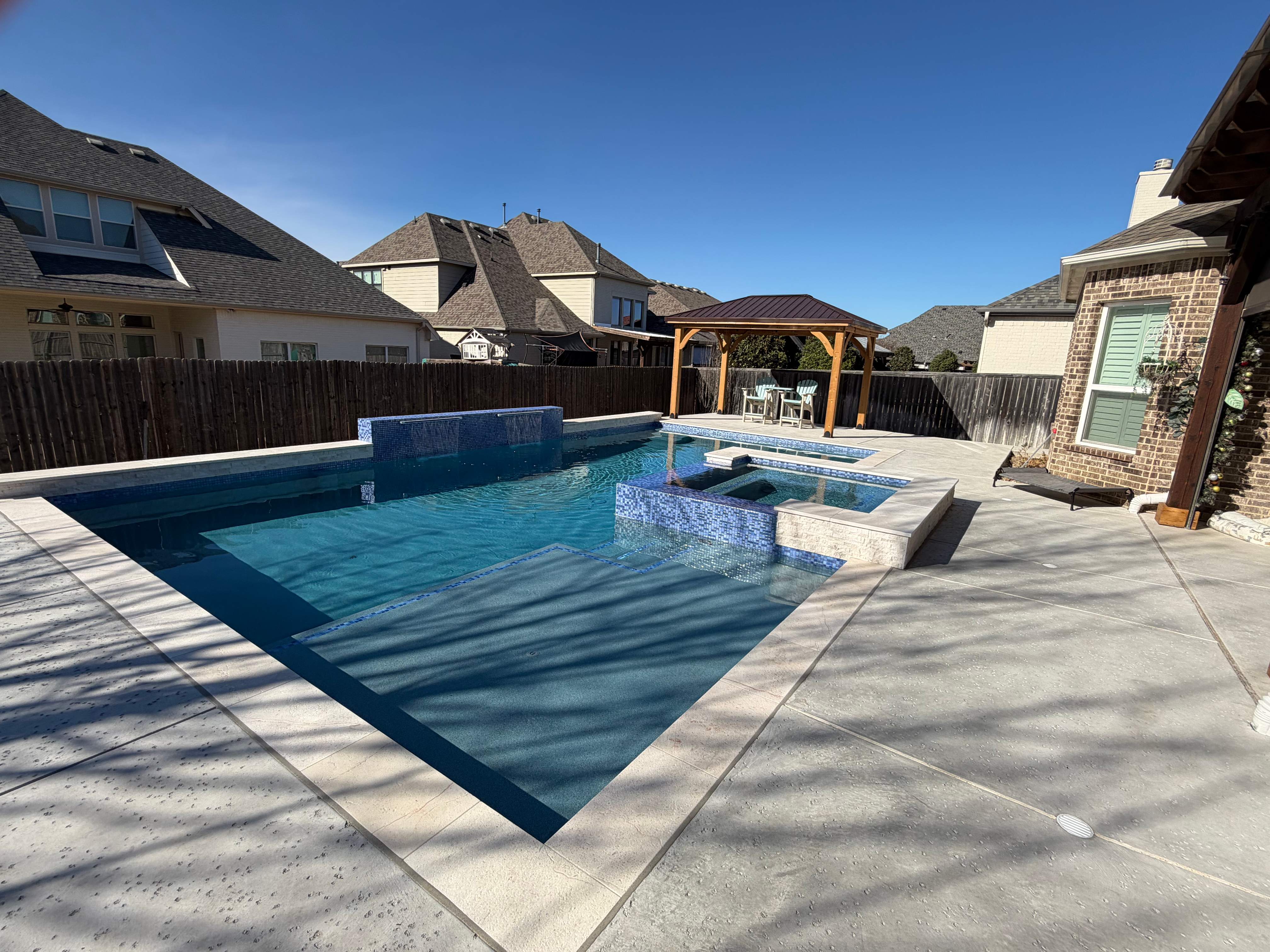 Geometric Pool with Raised Spa and Tanning Ledge by Pinnacle Pools and Spas - DFW