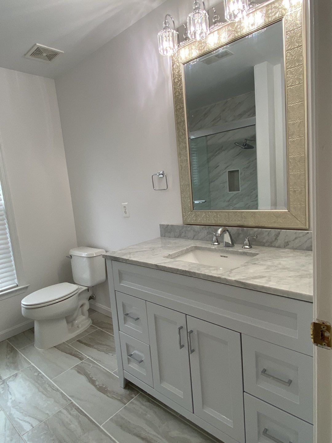 Bathroom Remodel using porcelain tiles , wood make vanetys , mirross , bathroom accessories  by Jesus Master Handyman LLC 
