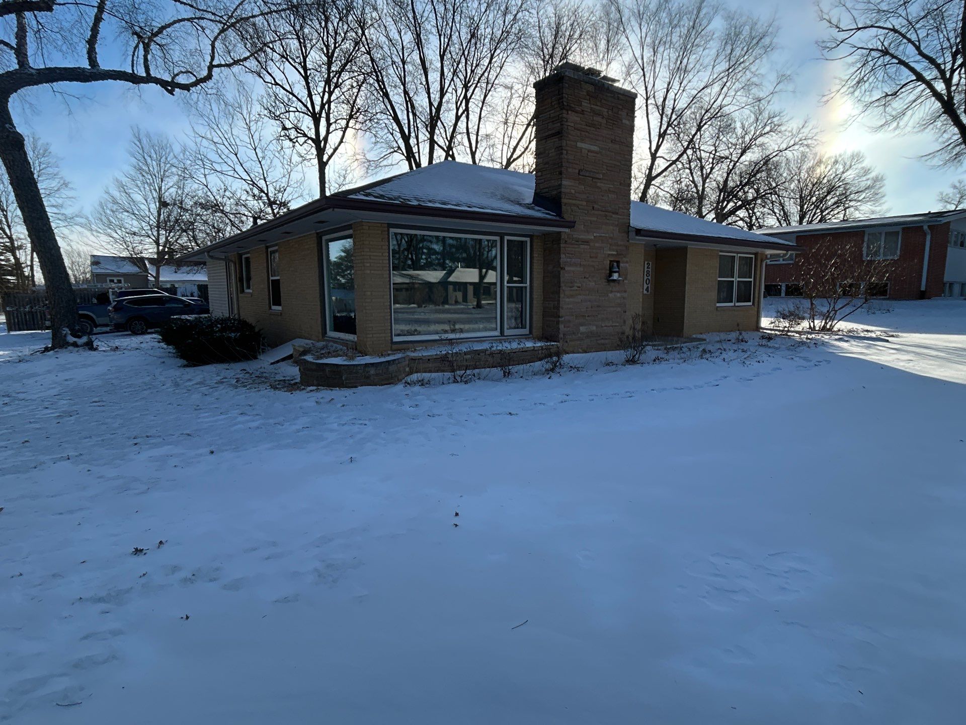 Black-Frame Pella Lifestyle Upgrade on a Partial Brick Home by United Windows and Siding LLC