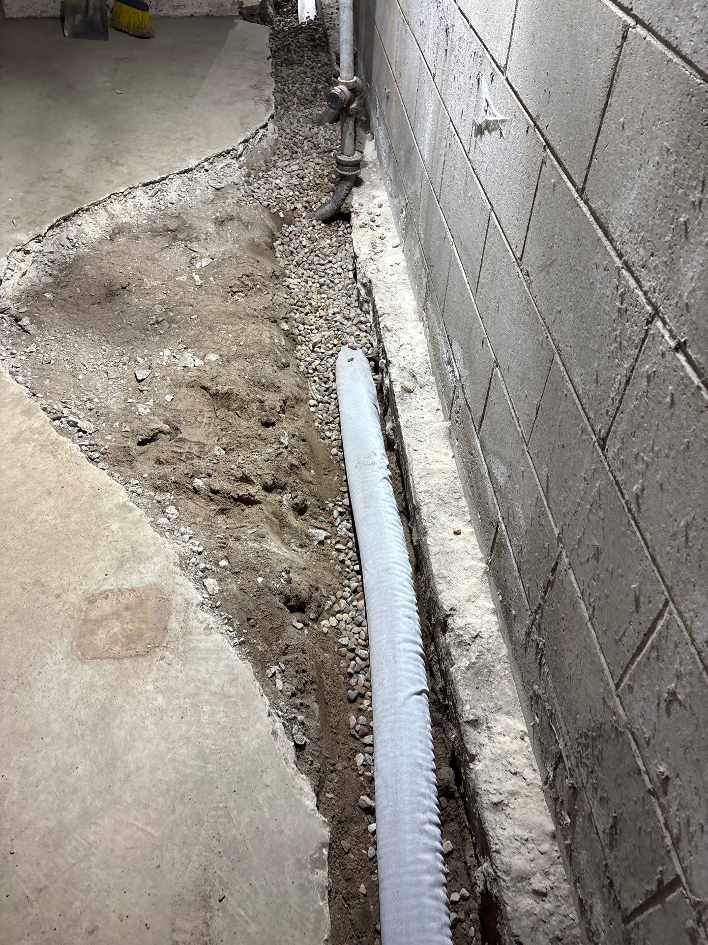 Interior Drain Tile & Buried Discharge in South Minneapolis by Waterproofing Northeast