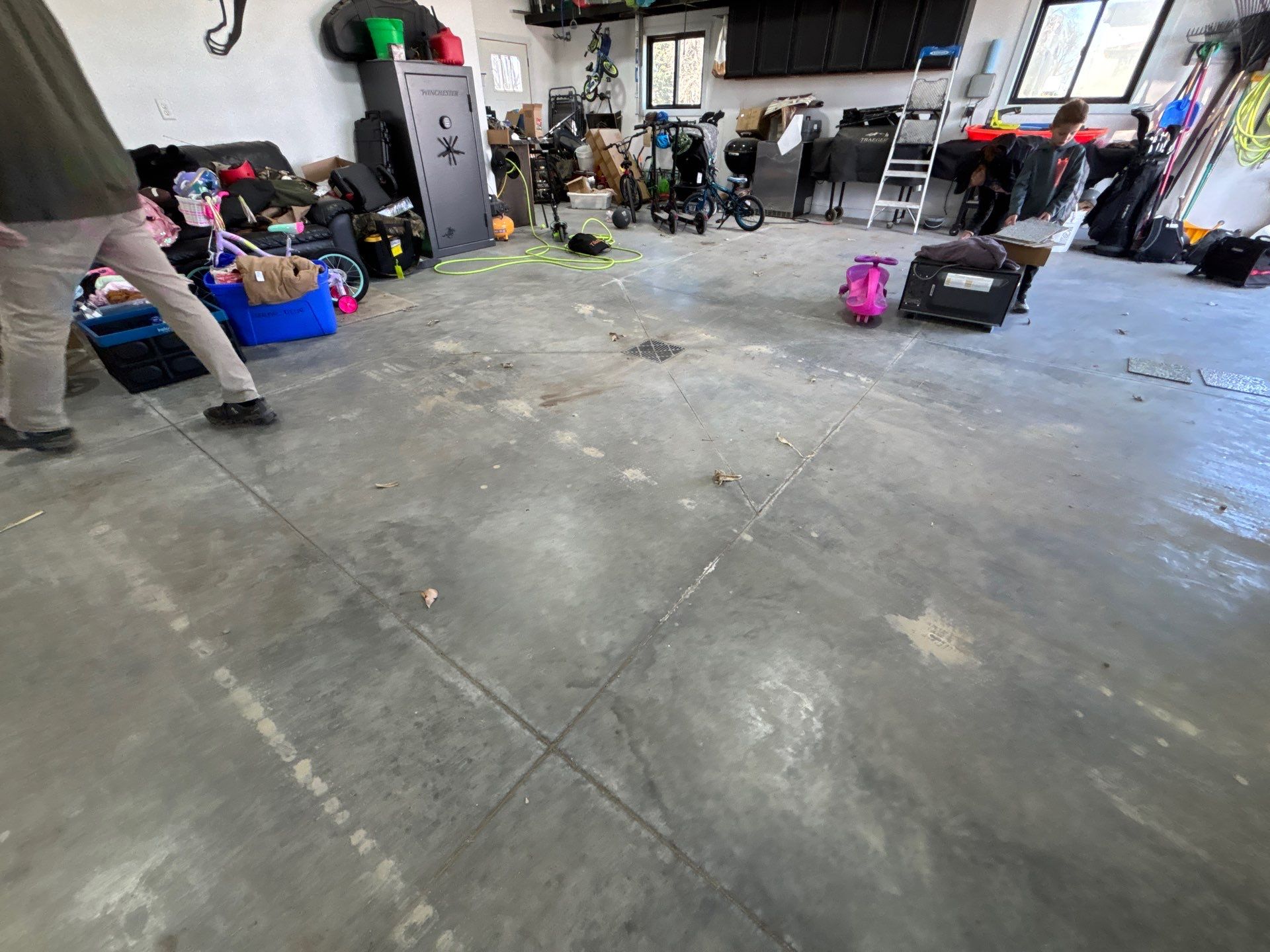 Speckled Polyaspartic Garage Floor Coating Installation in Dell Rapids by Select Painting, Coatings & Garage Cabinets