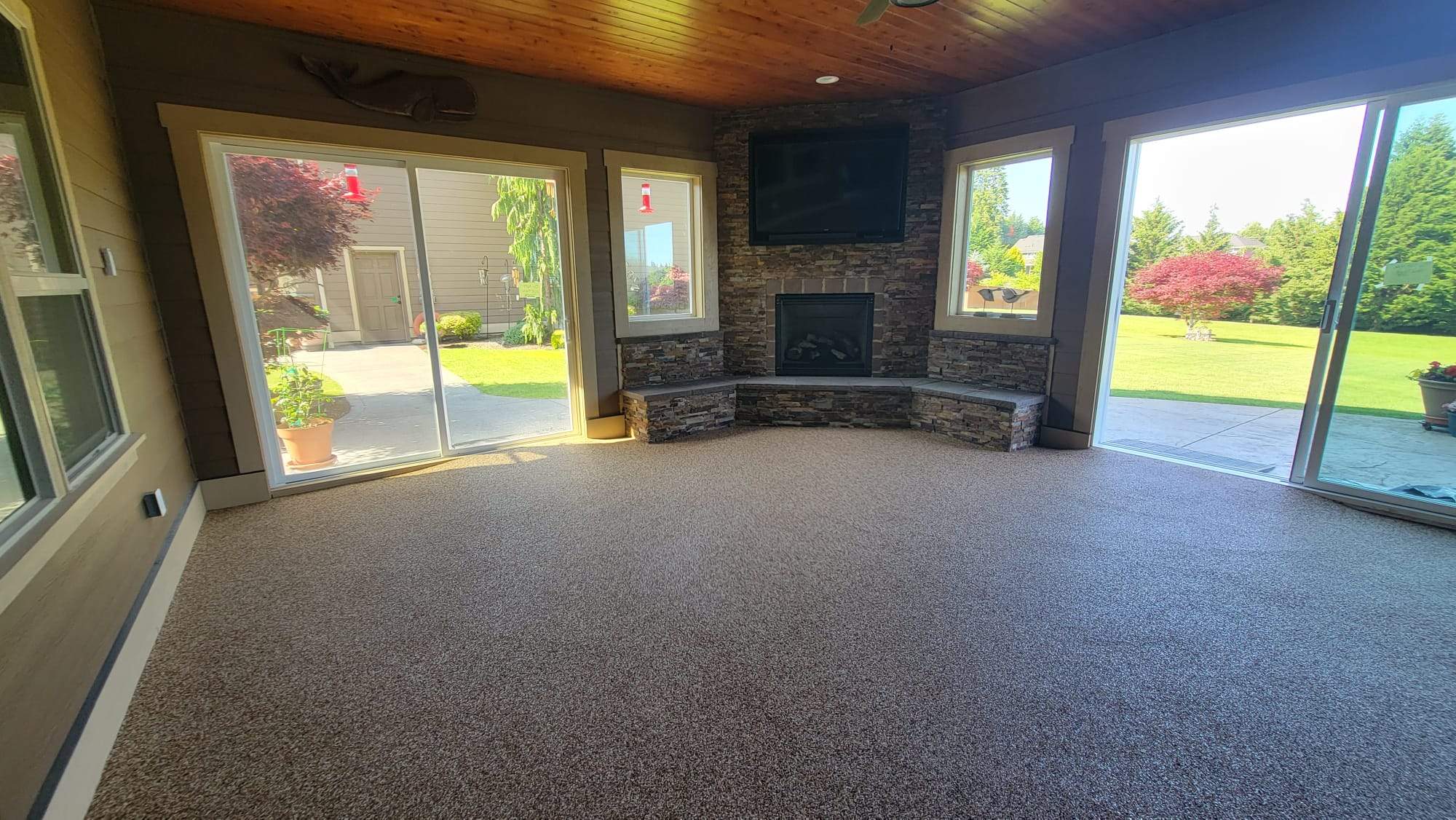 Warm Retreat Basement in Vuba Stone with Fireplace by Concrete Coating Experts Inc.