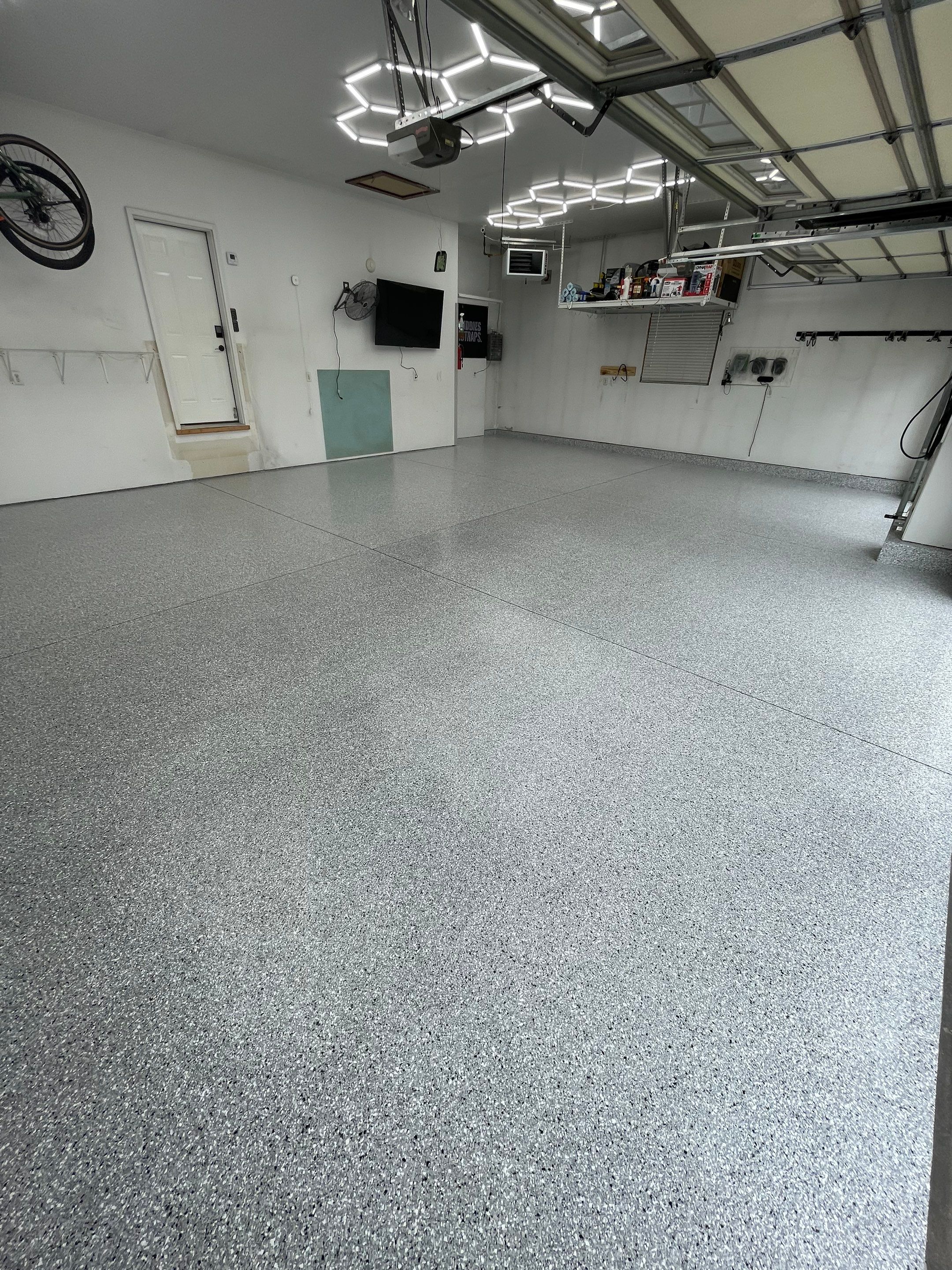 Feather Gray Epoxy Floor Coating Installation in Sioux Falls by Select Painting, Coatings & Garage Cabinets