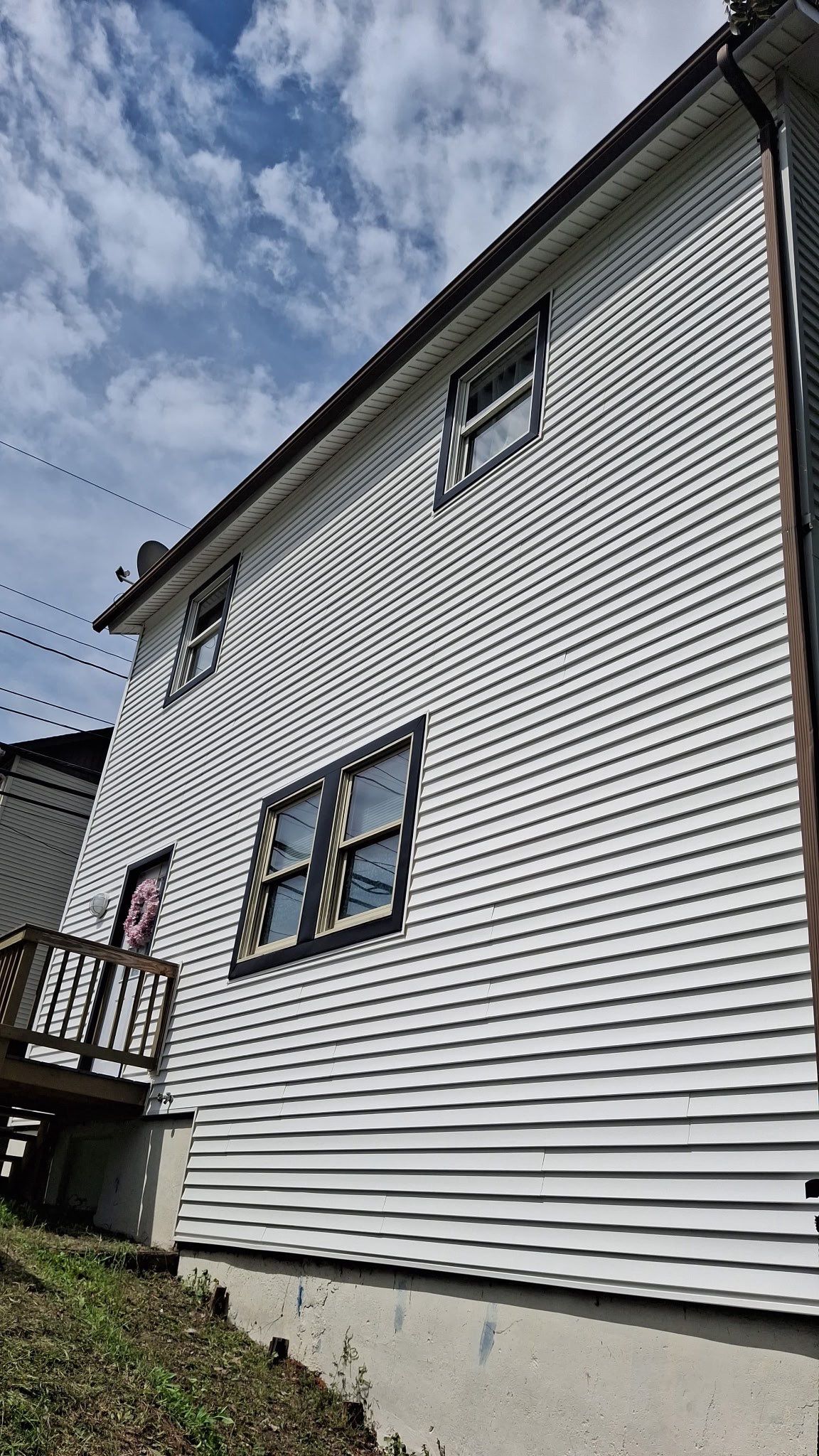 White siding  by Cousins Roofing Siding & Decks