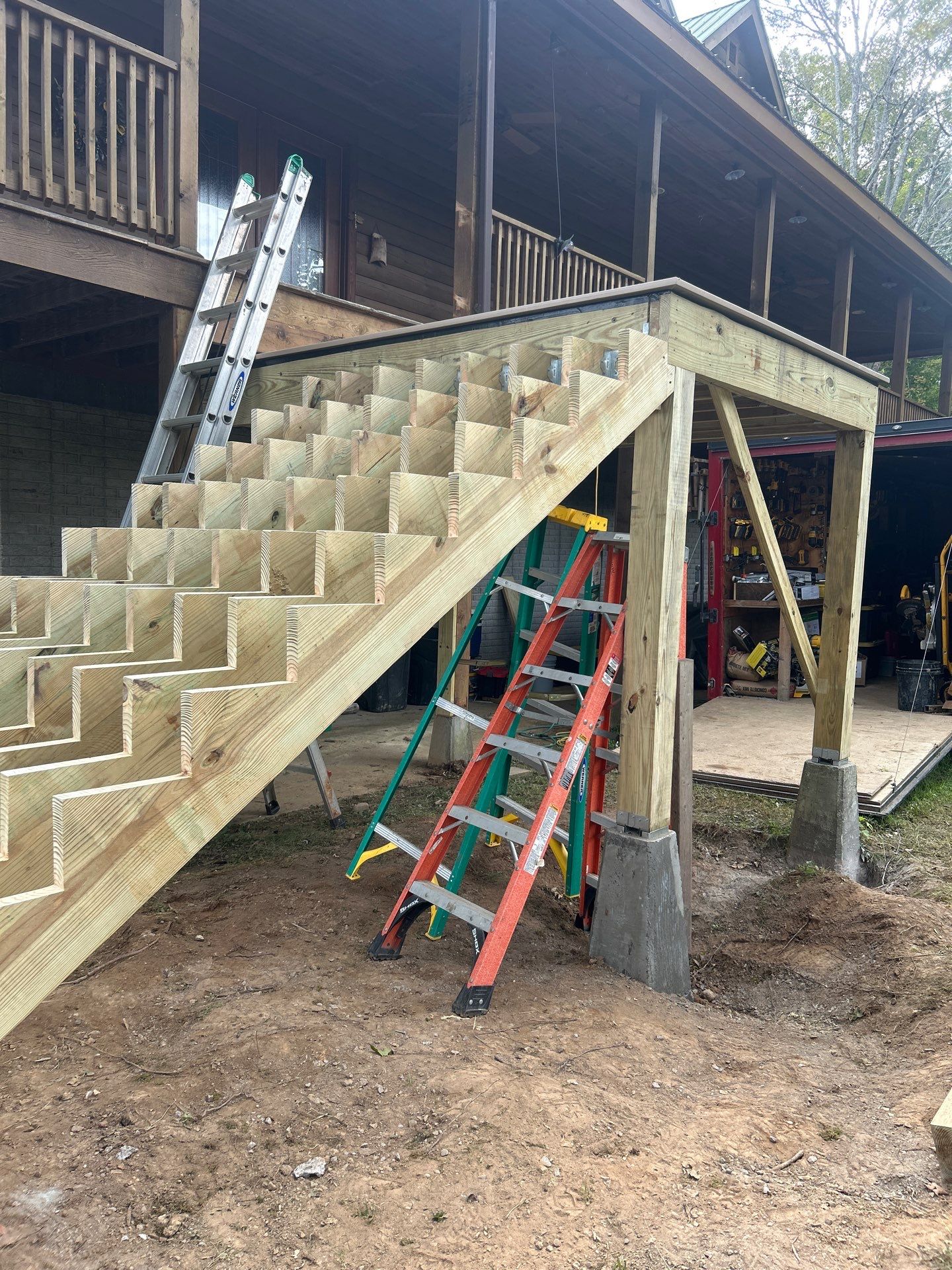 Log Cabin Wrap-Around Deck and External Staircase Installation in Caldwell by Walnut Hollow Decks & Outdoor Living