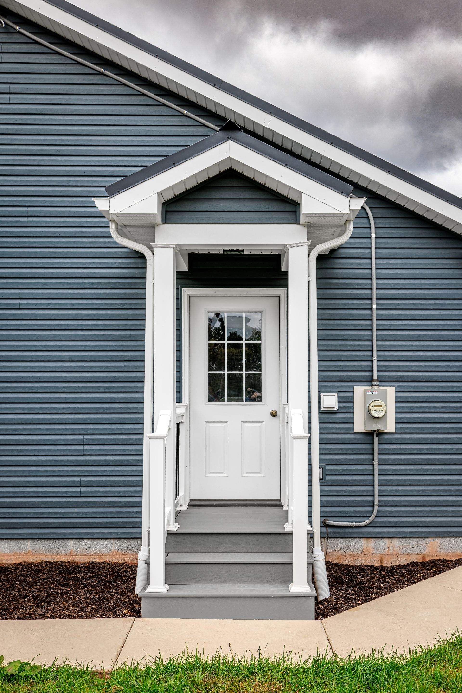 New Residential Addition with Blue Siding and Metal Roofing in Ashland by Esh Builders