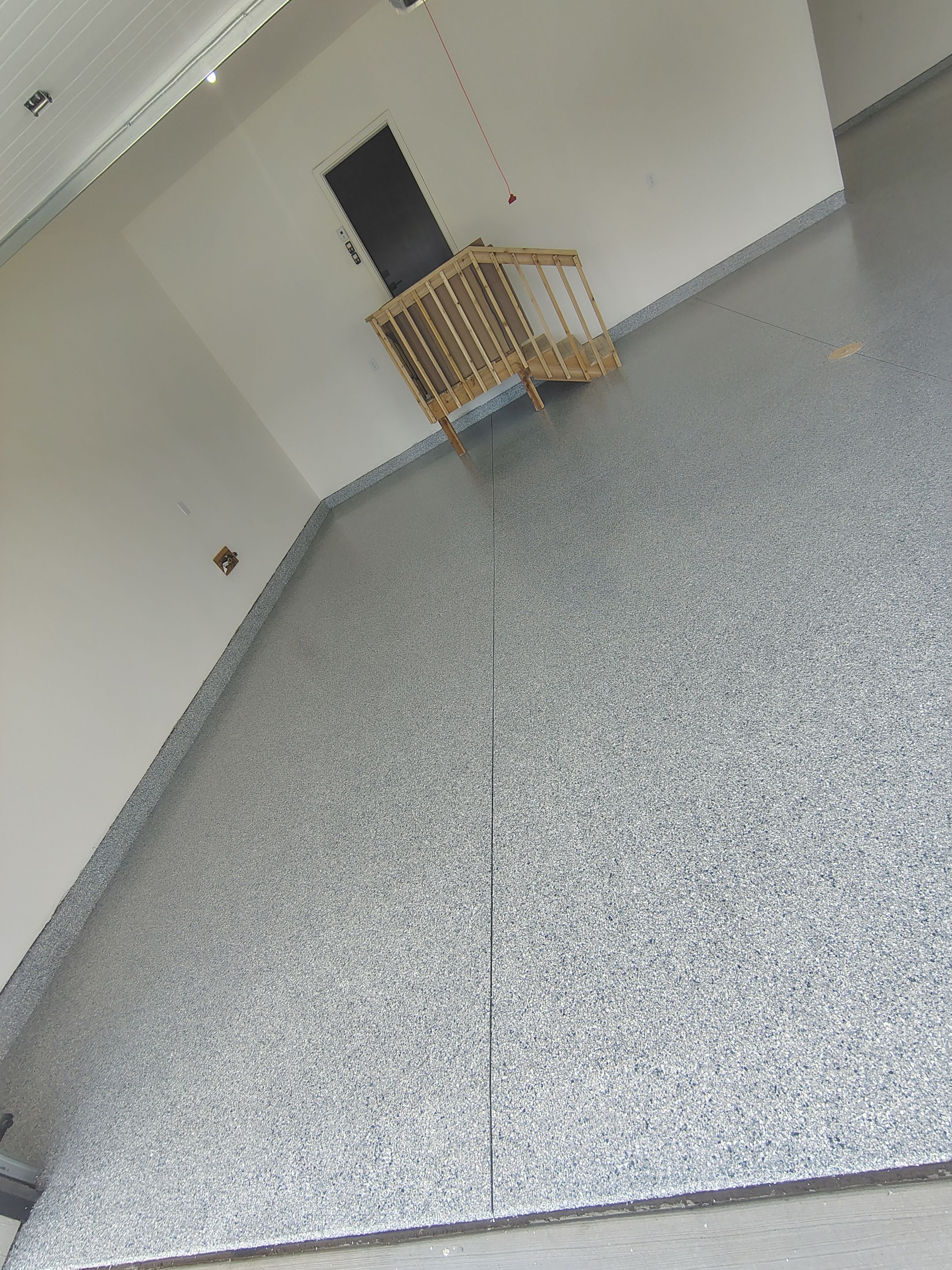 Sioux Falls Garage Floor Transformation with Gray Decorative Flake Coating by Select Painting, Coatings & Garage Cabinets