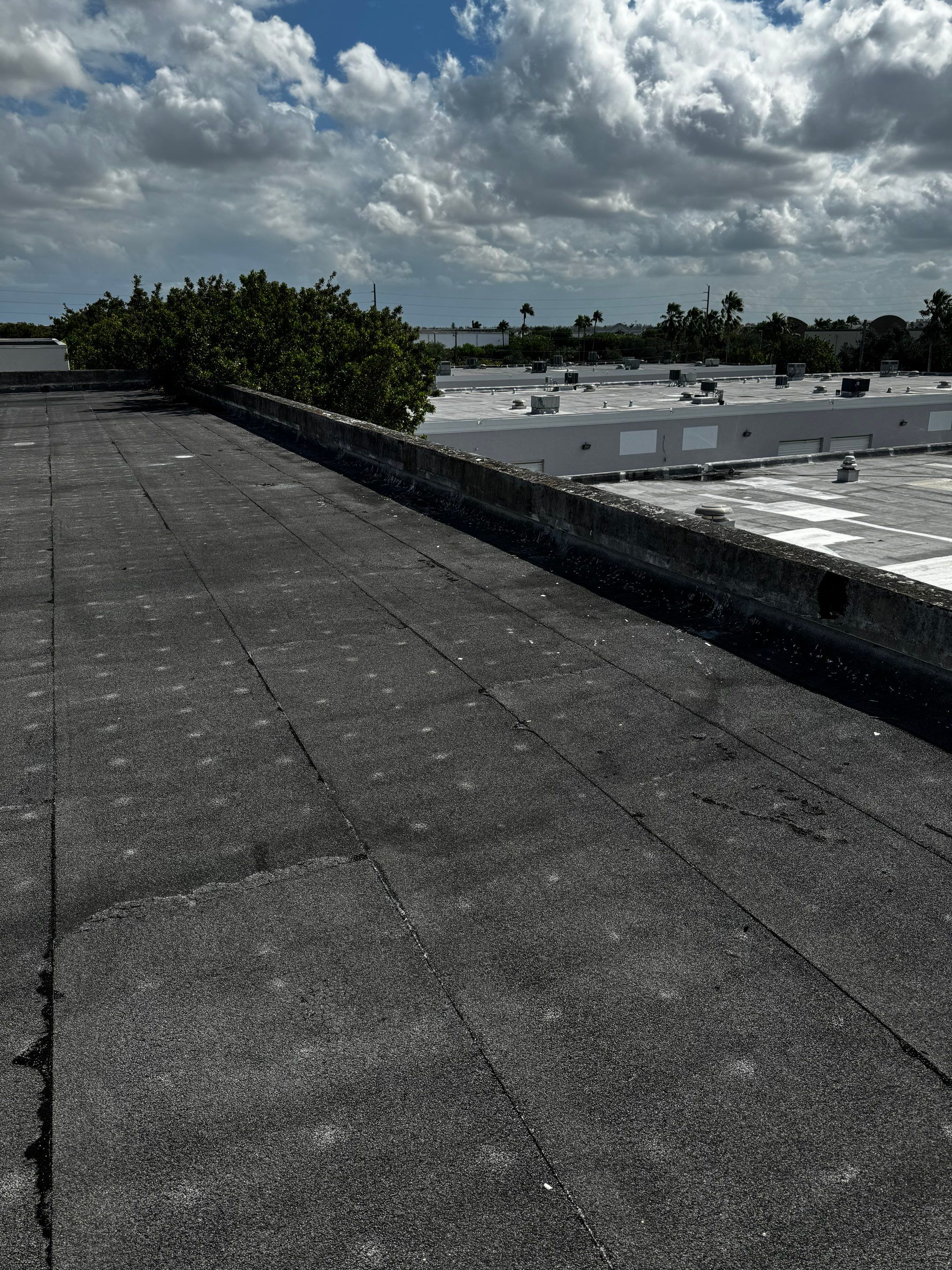 White TPO Membrane Roof Replacement at Doral Commercial Building by AJF ROOFING INC