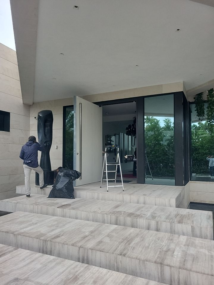 Custom Material Pivot Door installation by Impact Precious Wood Inc.