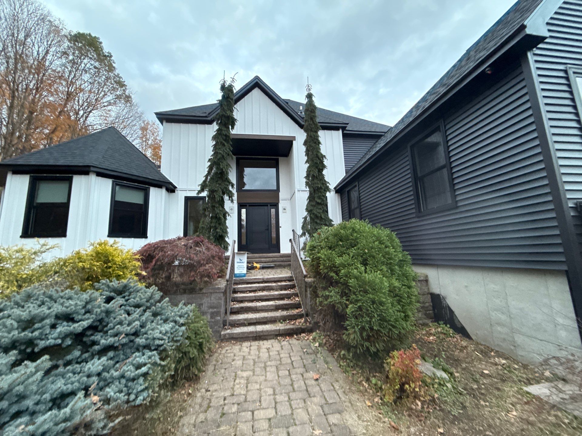 Bold Siding transformation with Cert Cedar Board & Batten S12, White, and Cert Monogram D/4 x 12'6" clapboard, Tuxedo by DiGiorgi Roofing and Siding Inc