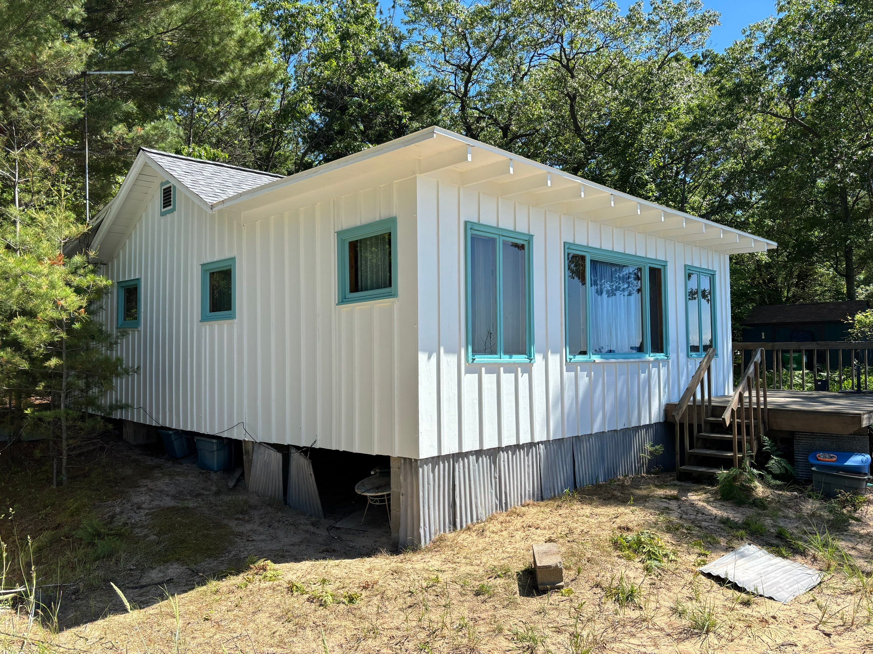 Lakeside Cottage Exterior Painting and Teal Trim Restoration in Mears by Gordon Painting
