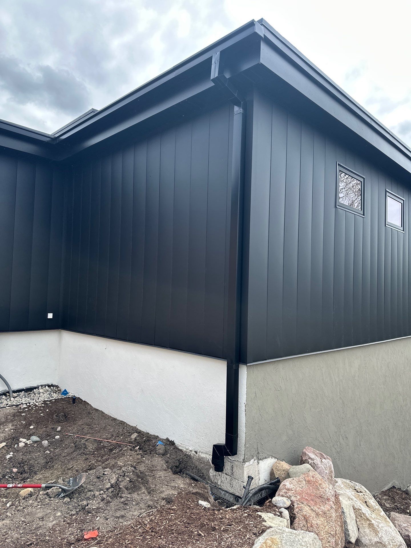Matte Black Gutter and Downspout Installation in East Jordan by Rainbow Seamless Systems