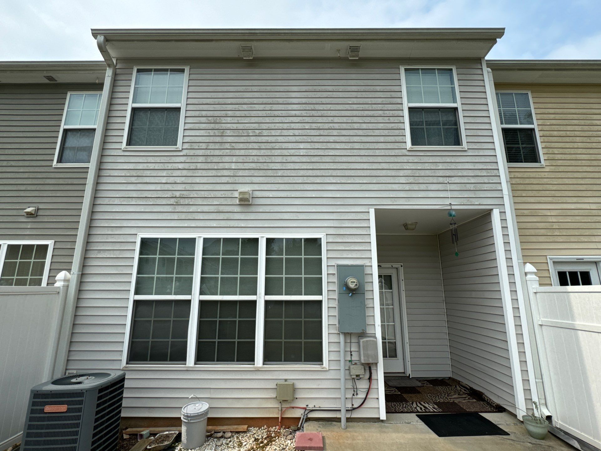 pressure washing exterior siding to remove dirt buildup and stains