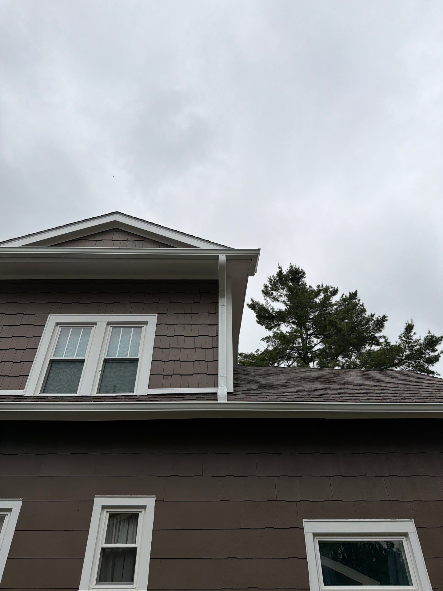 White Gutter and Downspout Installation in Boyne City by Rainbow Seamless Systems
