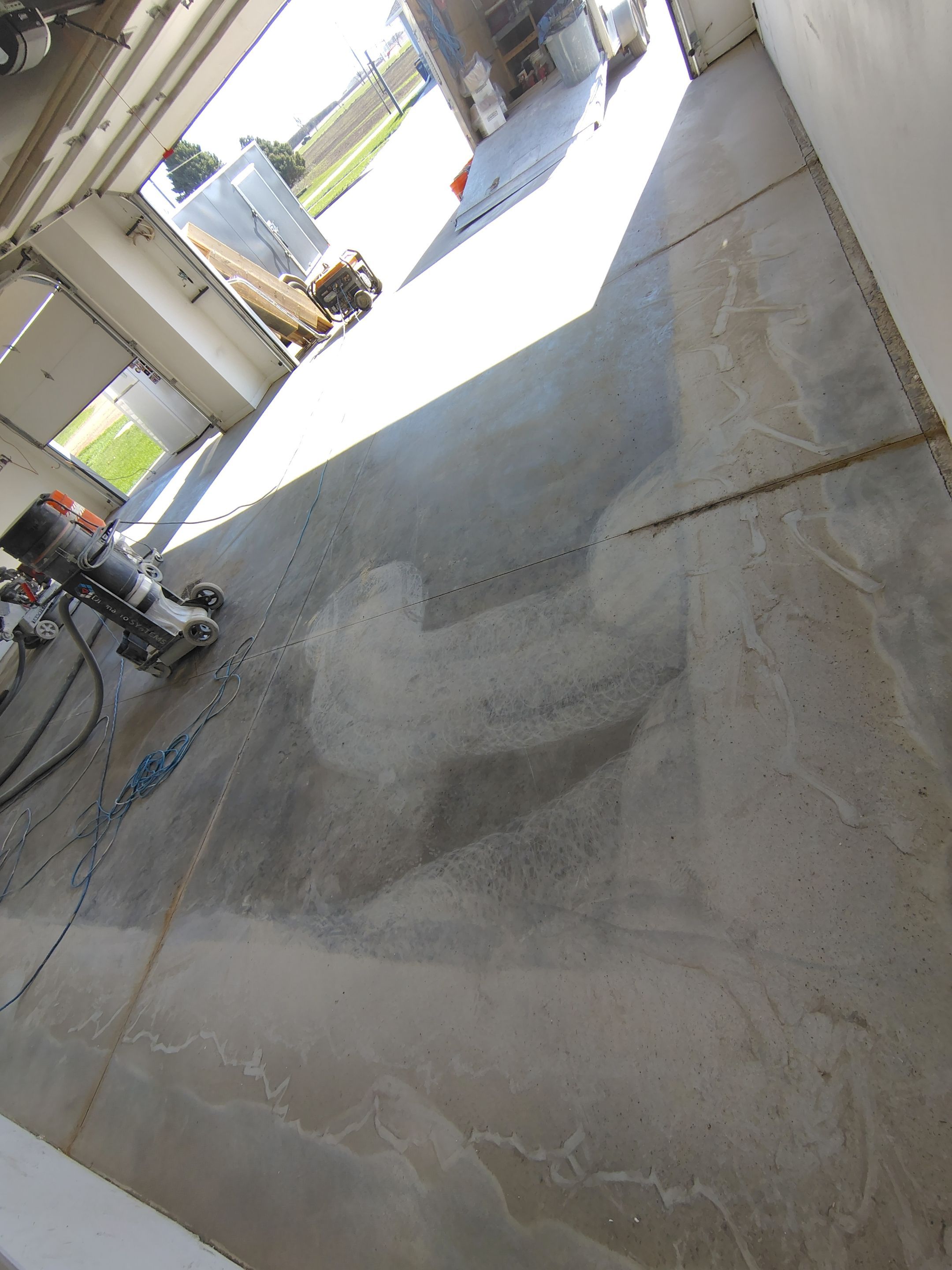 Speckled Polyaspartic Garage Floor Coating Installation in Dell Rapids by Select Painting, Coatings & Garage Cabinets