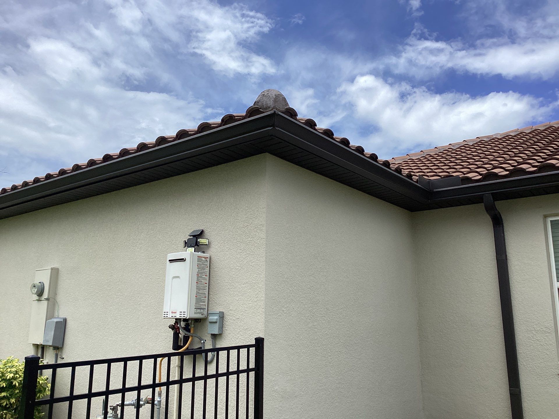 Musket brown seamless gutters with splash guards, new downspouts, and extensions in Bradenton, FL by Gutter Professors