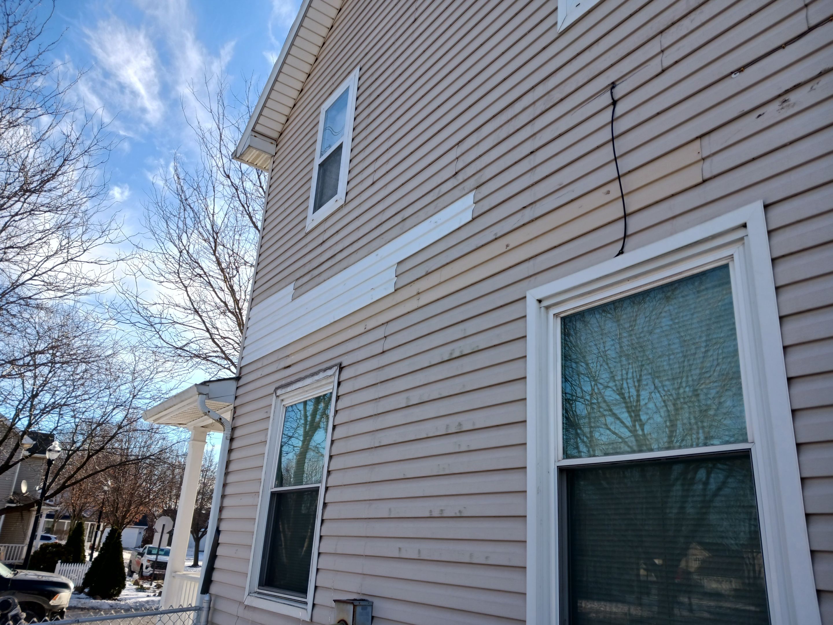 Wind damage to Siding: Insurance paid for full replacement of all siding by Absolute Roofing and Construction
