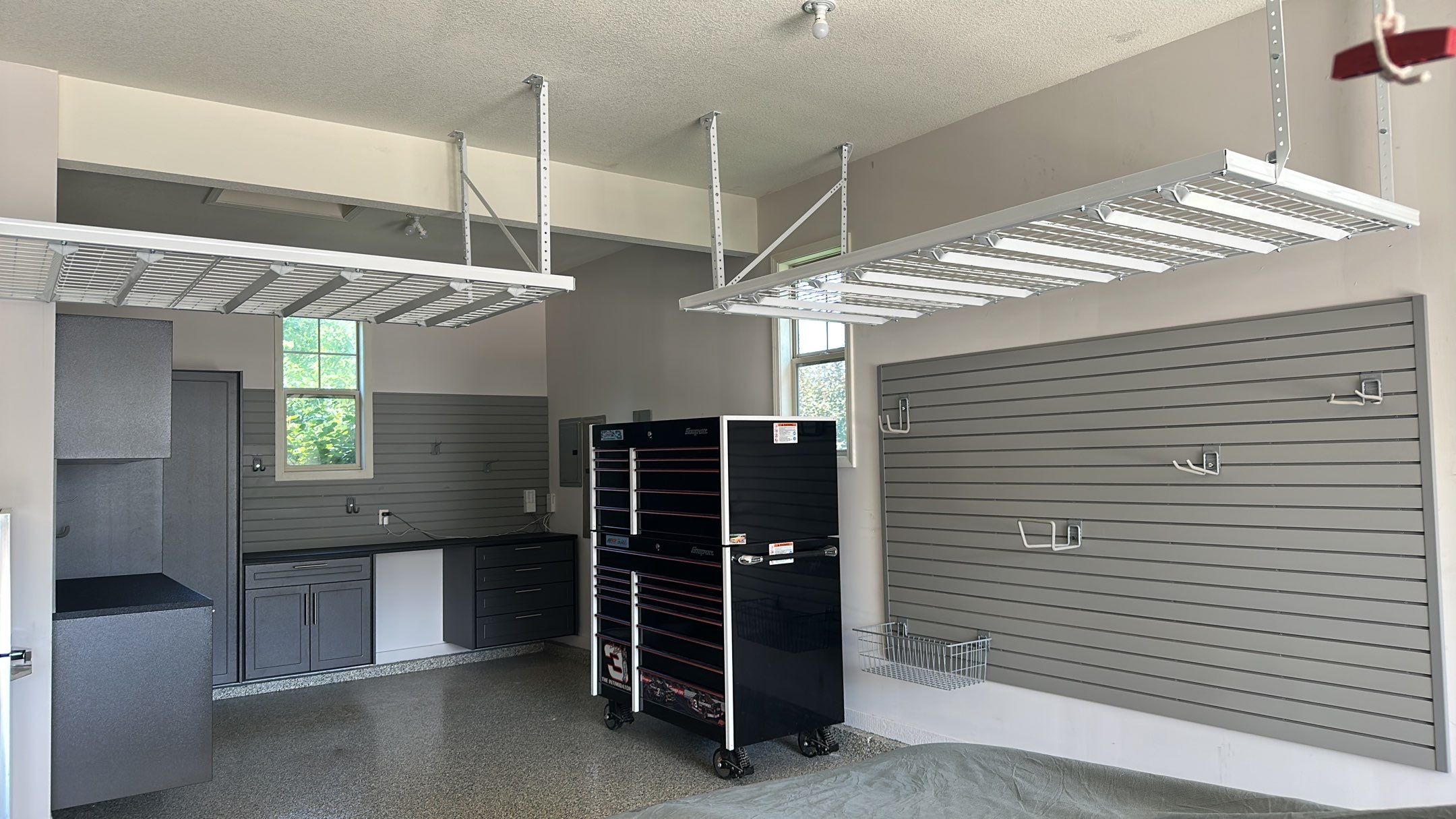 Lori H. upgrade her garage with cabinets and overhead racks by Banner Garage