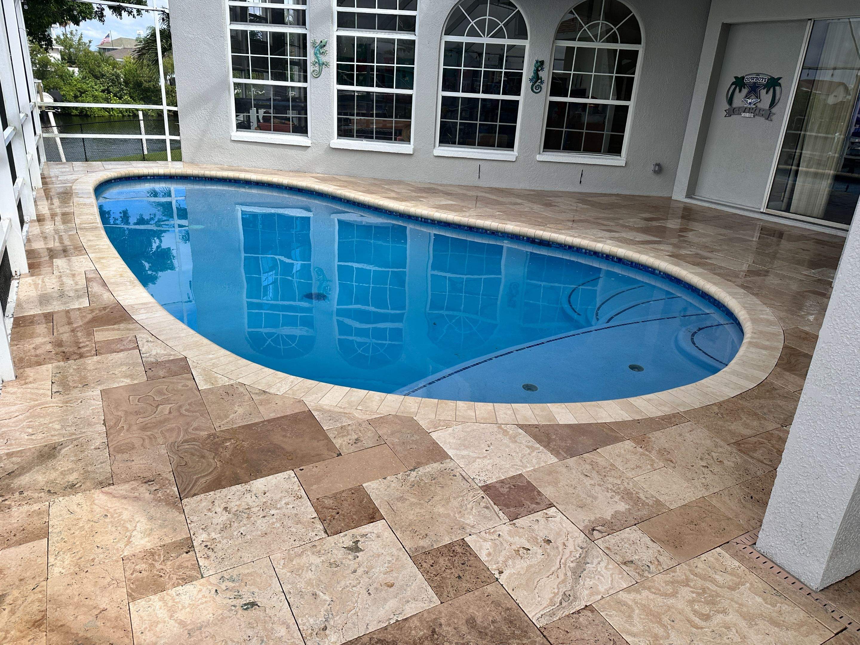 Travertine Sealing and Stripping for a Waterfront Pool Deck in Apollo Beach by Supreme Paver Experts