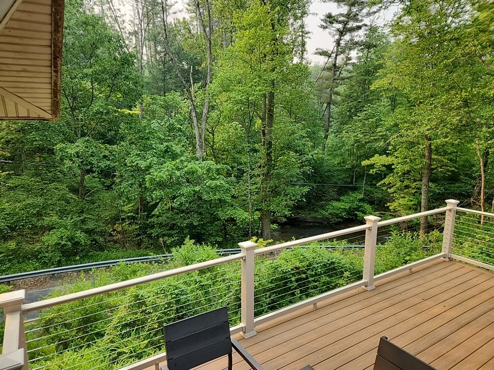 Deck installation using cable railing. by Burke Home Services