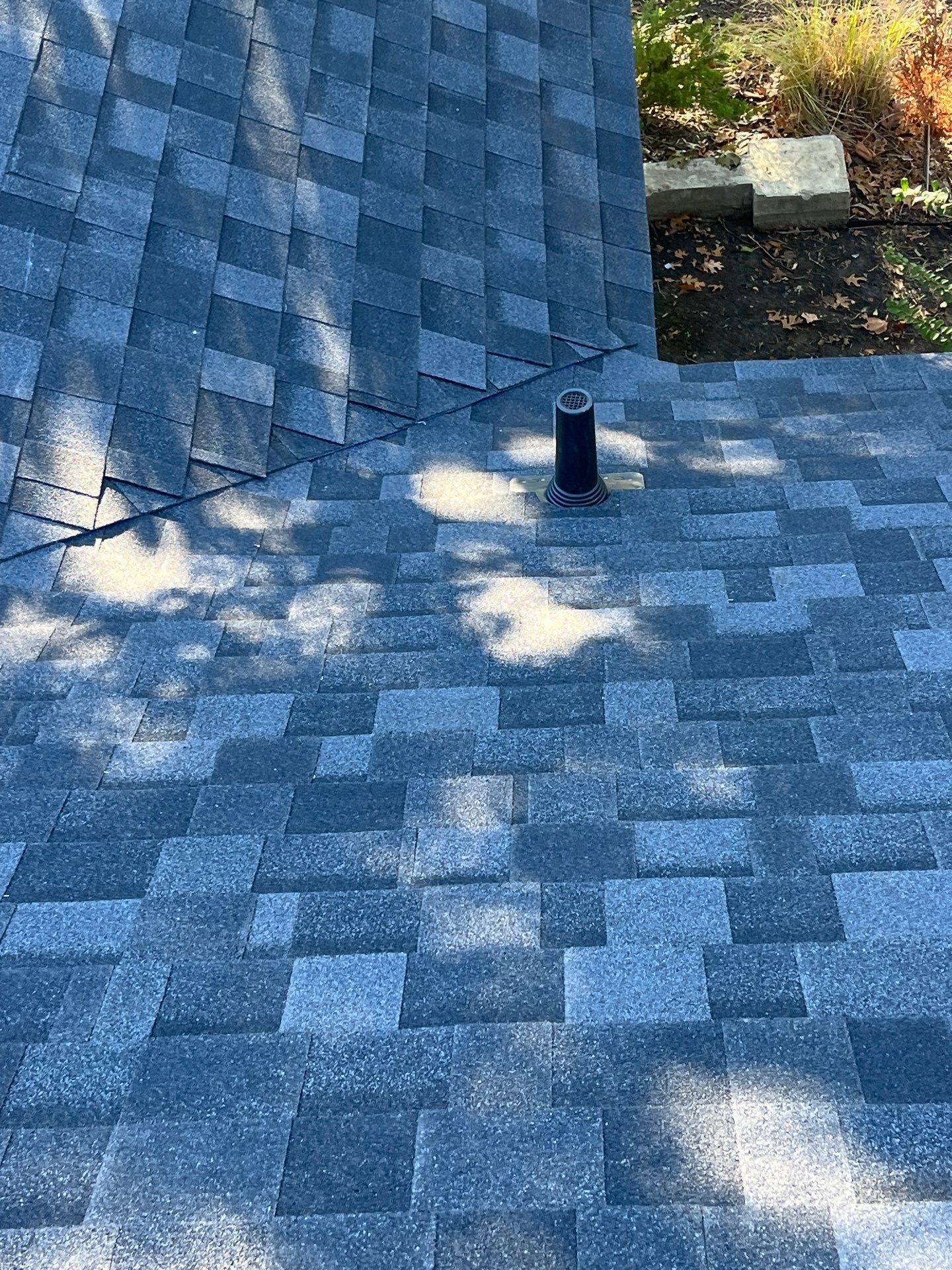 White brick with IKO Granite Black by Tejas Roofworks + Restoration