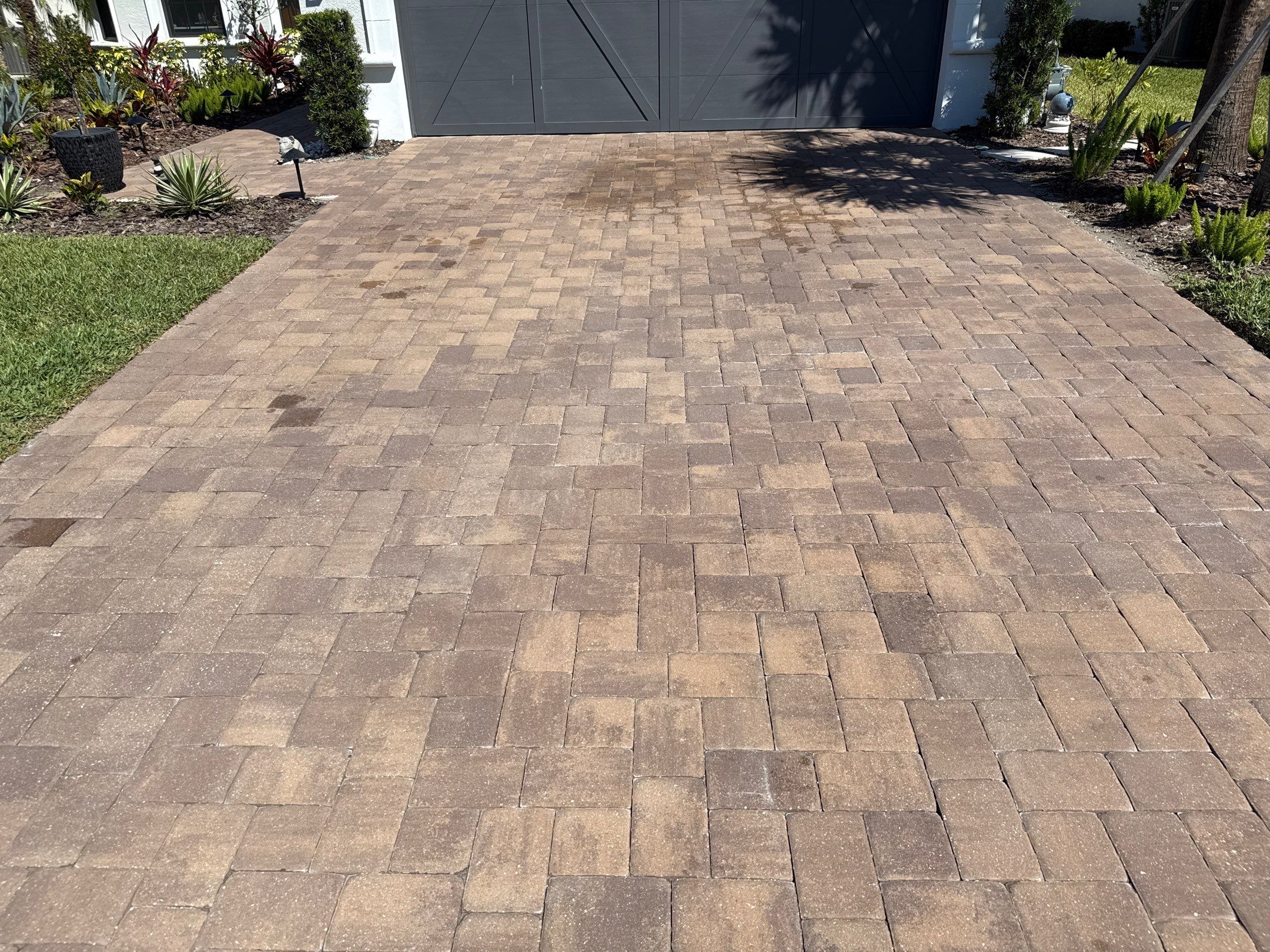 Oil Stain Removal on Paver Driveway | Esplanade at Artisan Lakes, Palmetto FL by Sunshine AquaWash