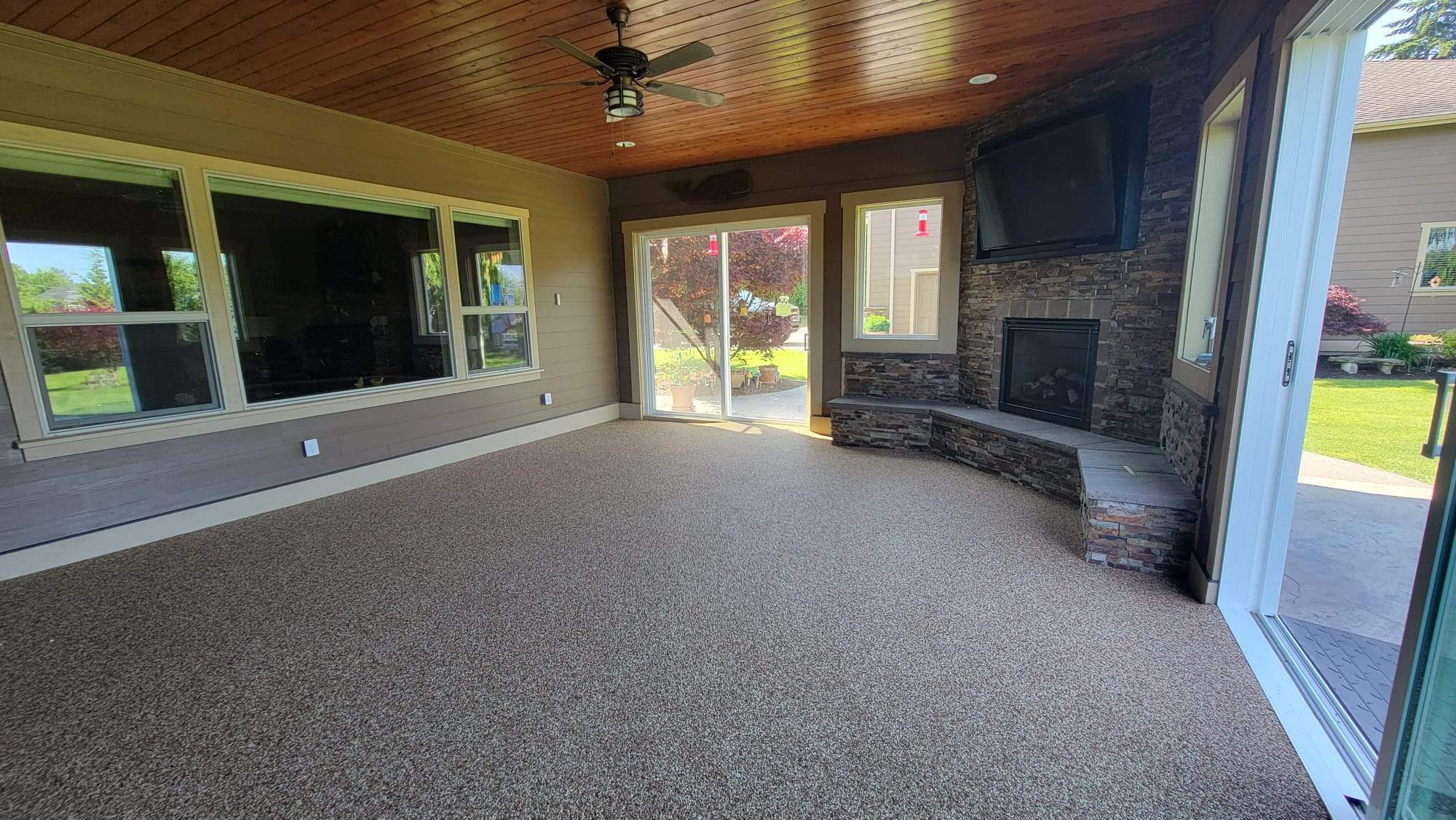 Warm Retreat Basement in Vuba Stone with Fireplace by Concrete Coating Experts Inc.