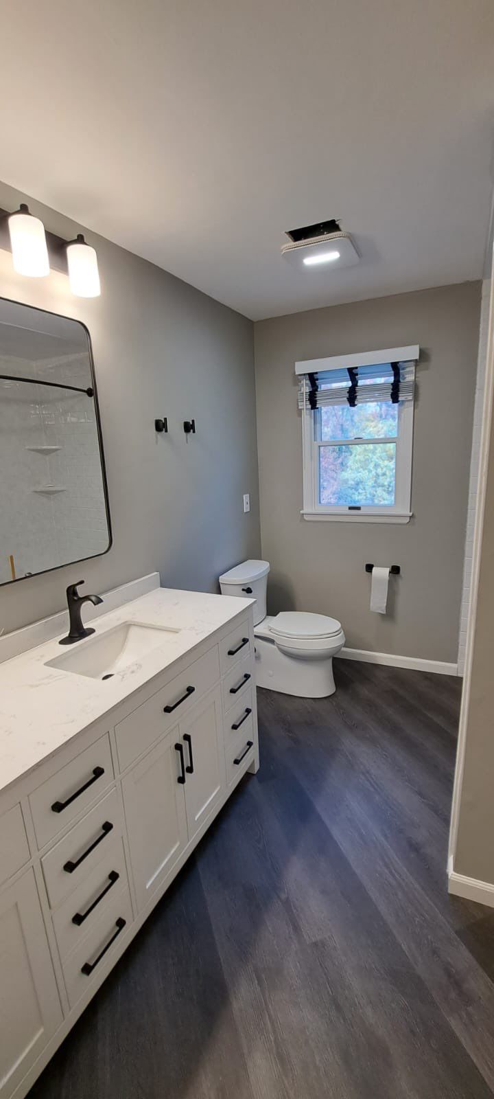 Bathroom Remodel using LVP Flooring by Home Concepts Construction