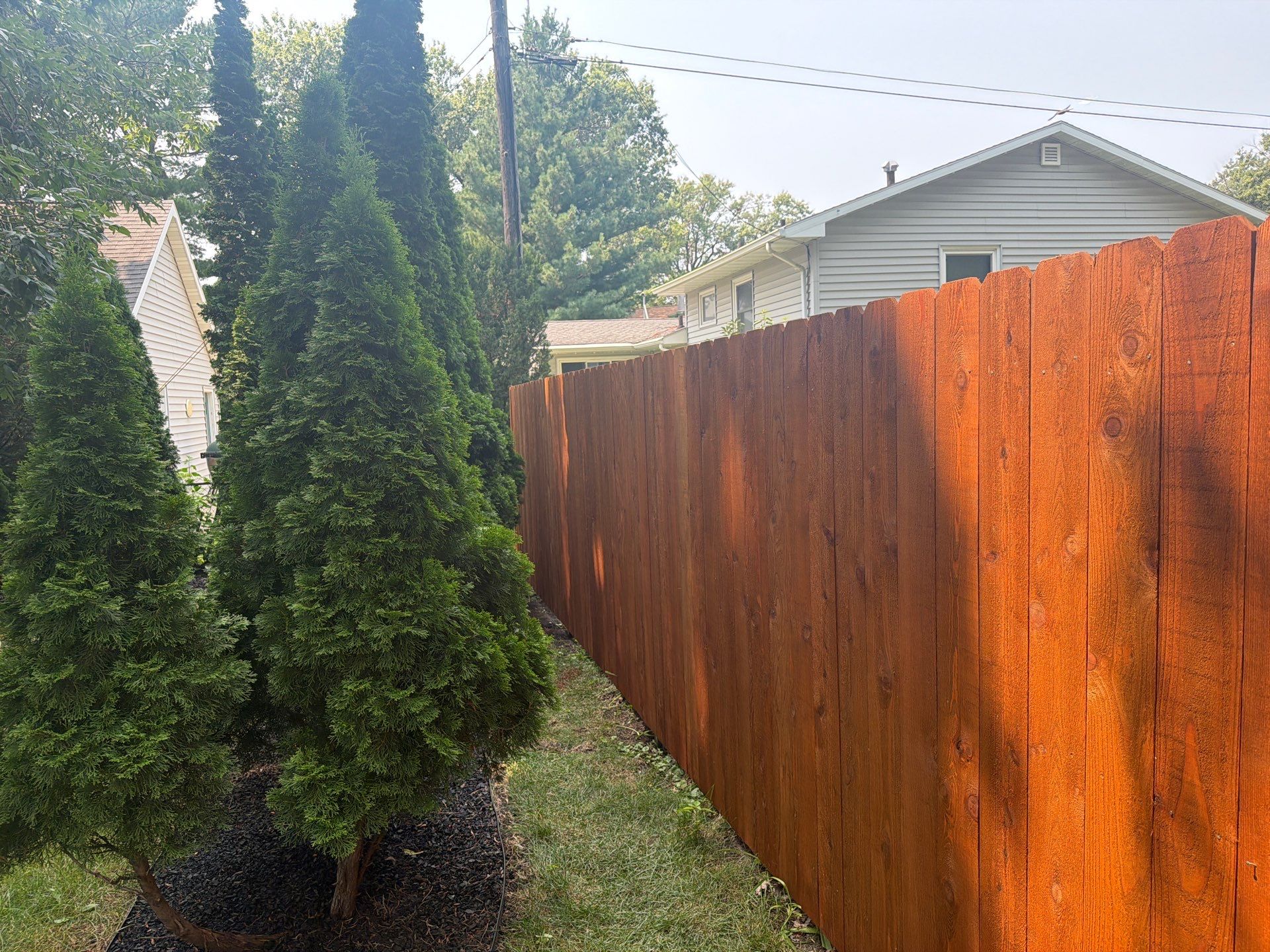 Pecan Cedar Privacy Fence Installation with Scalloped Top in Cedar Falls by Perfect Picket Fence and Stain