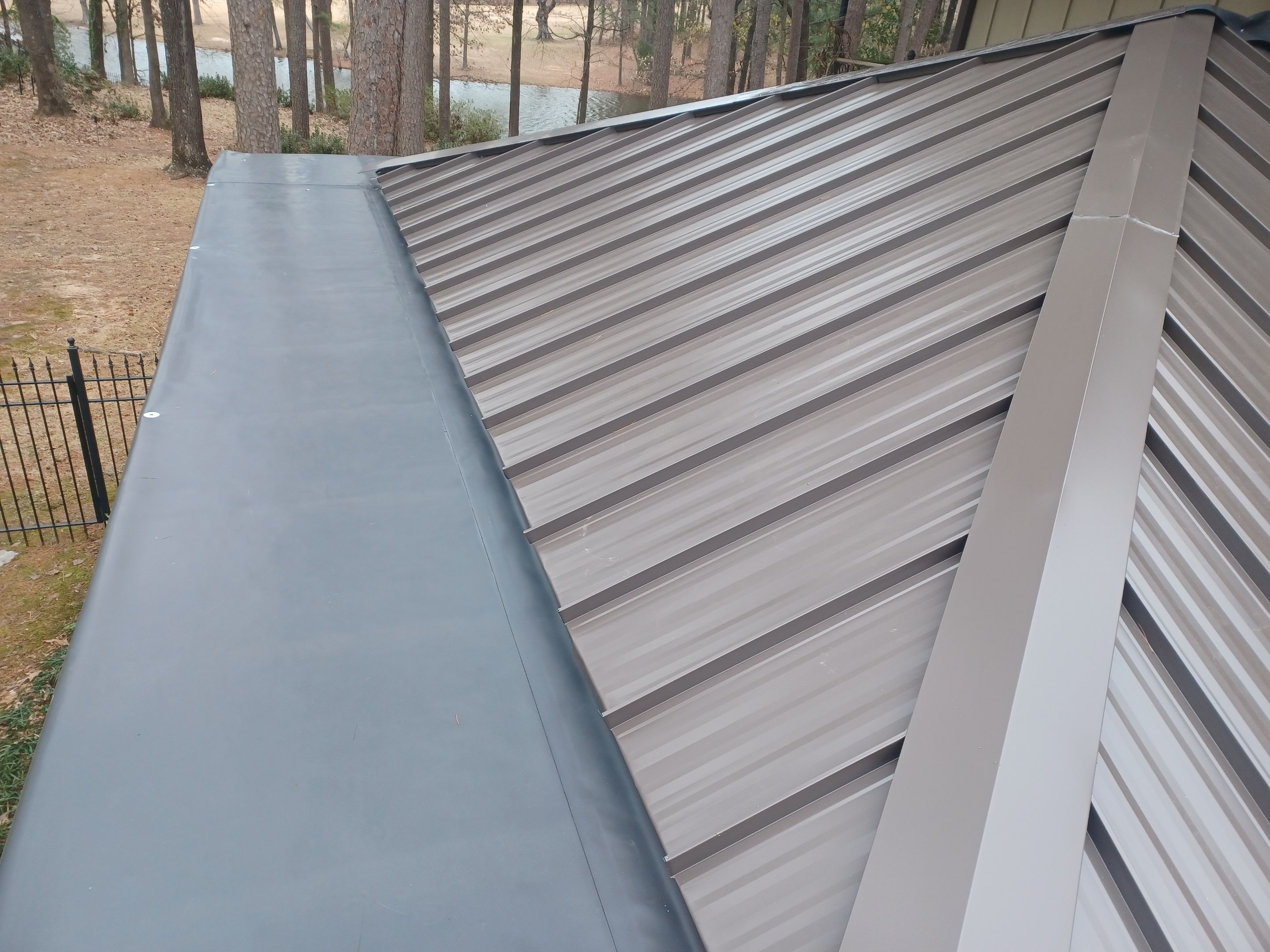 Residential Roofing Installation using PVC membrane and 24 gauge Standing Seam Metal by Hostetler Roofing