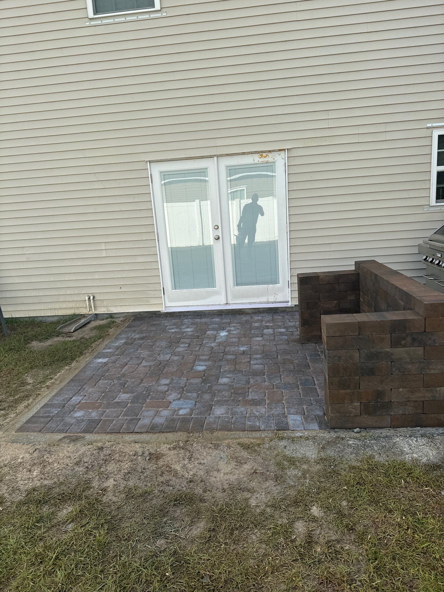 Custom Herringbone Paver Patio and Retaining Wall in Bluffton by Lowcountry Scapes, LLC