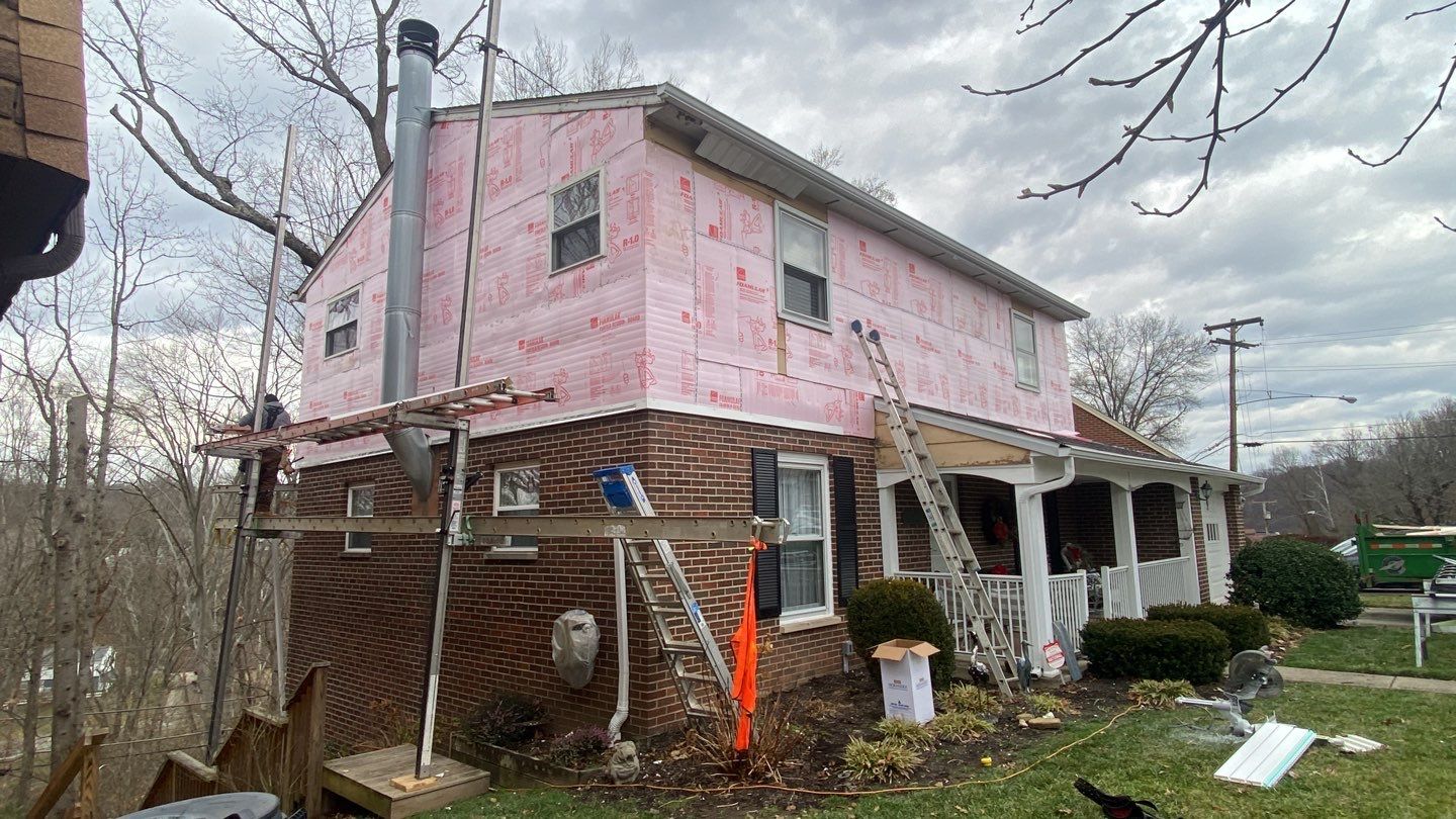Replace dated vinyl siding with new white exterior Portfolio vinyl siding  by Secure Construction Company Inc