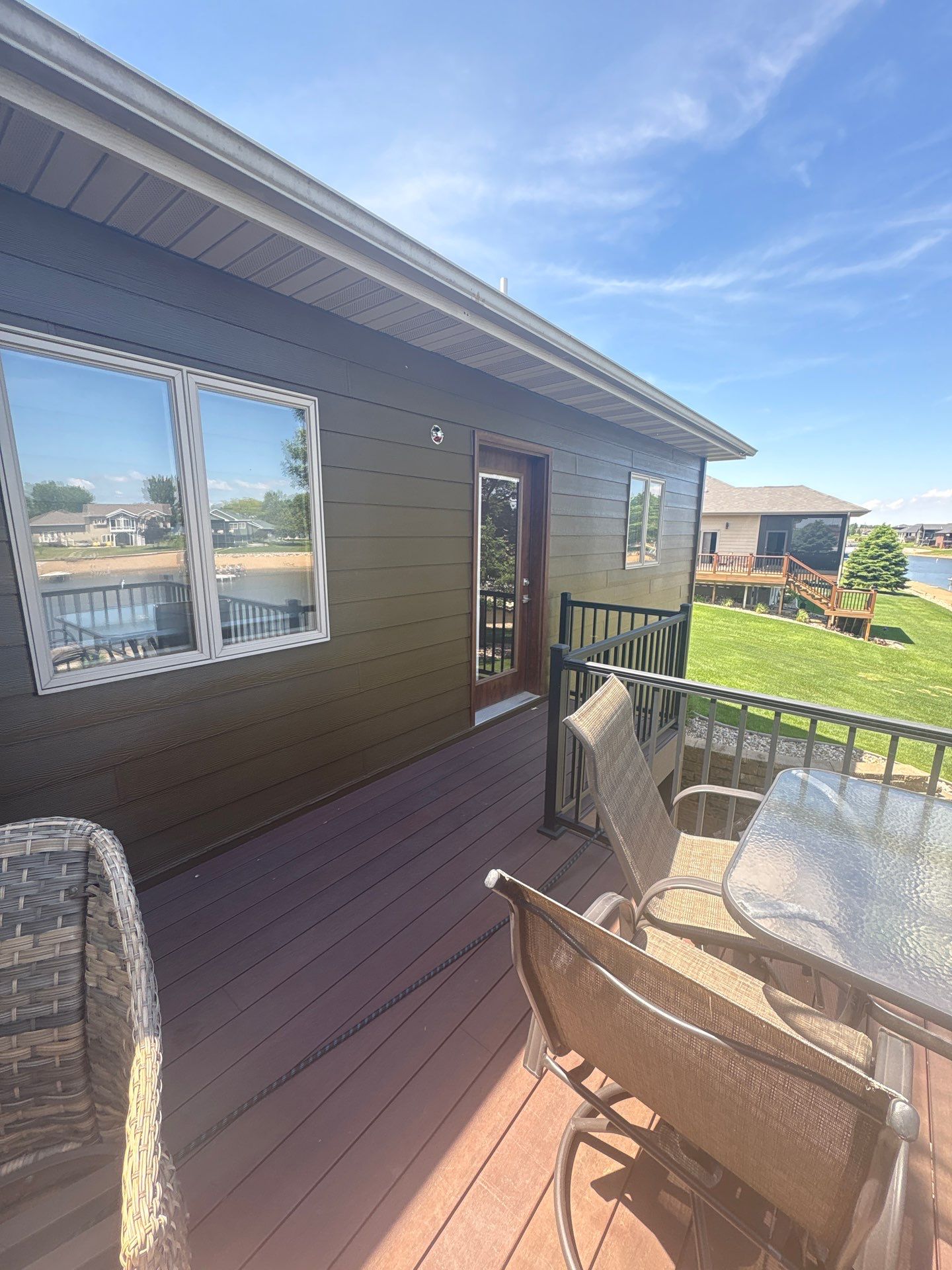 Full Exterior Renovation with Stone Veneer and Composite Decking by Select Painting, Coatings & Garage Cabinets