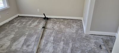 Stretching Out a Buckled Carpet