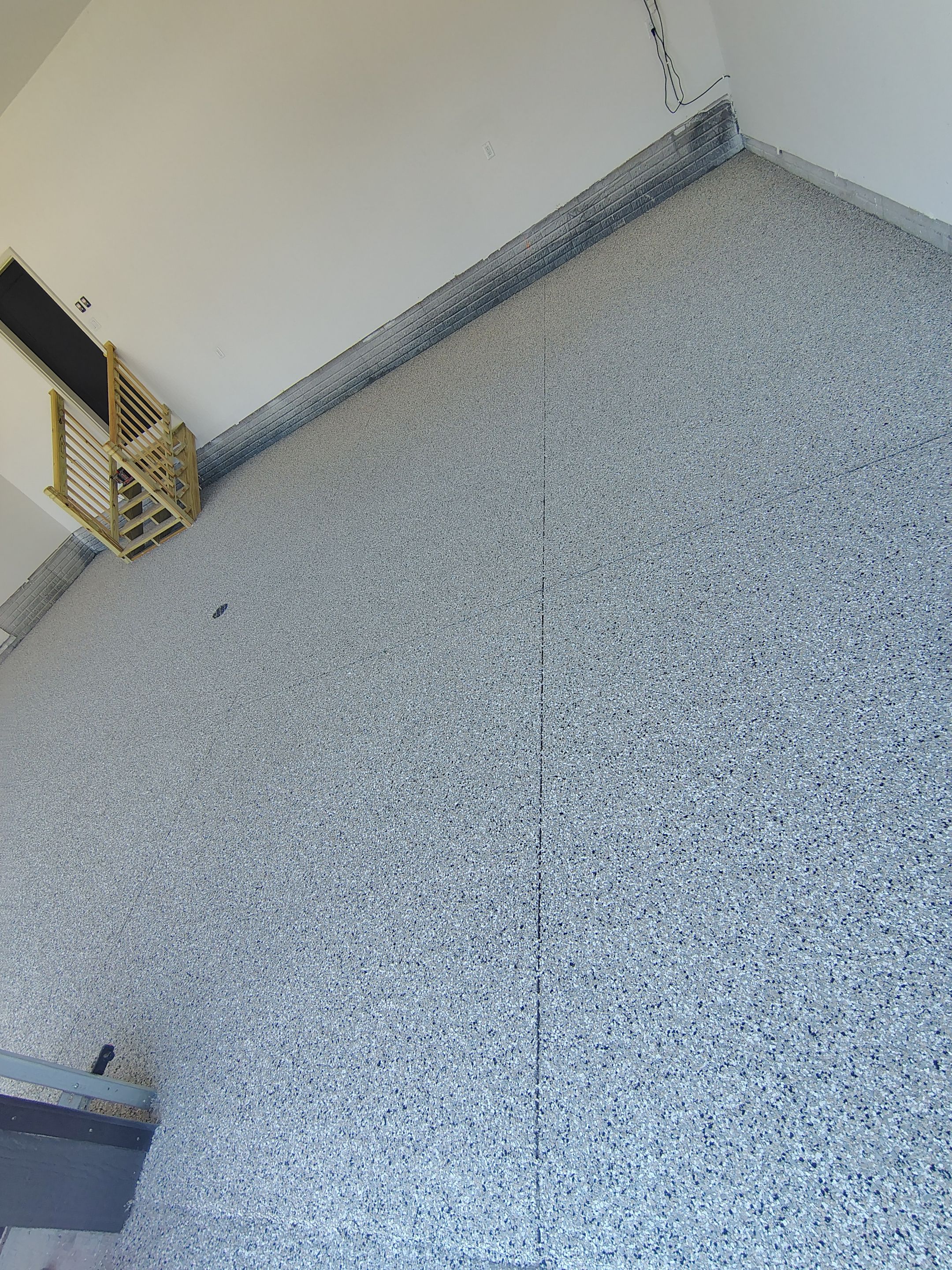 Cabin Fever Decorative Flake Garage Floor Coating in Sioux Falls by Select Painting, Coatings & Garage Cabinets