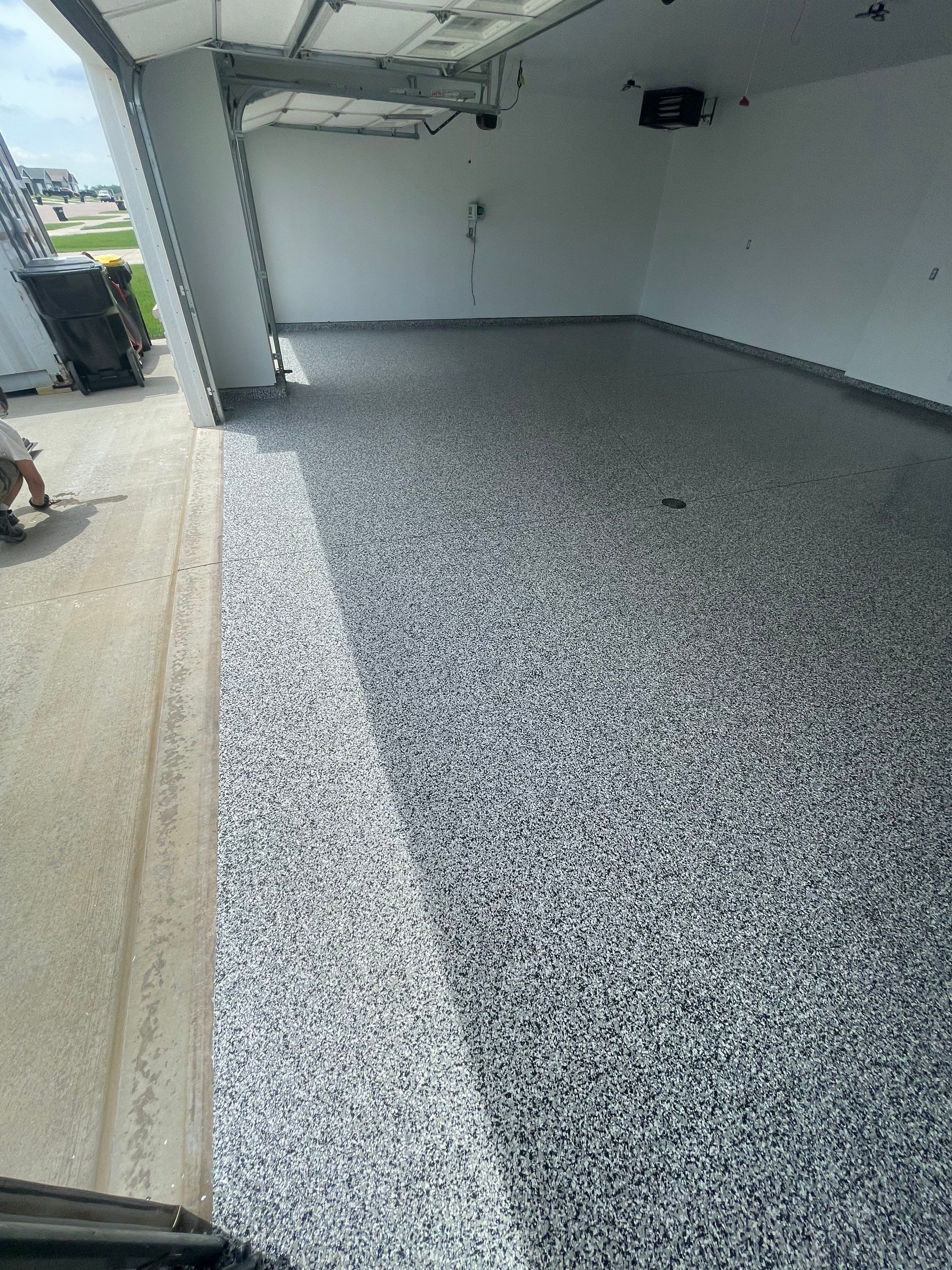 Grey Flake Epoxy Garage Floor Coating in Sioux Falls by Select Painting, Coatings & Garage Cabinets