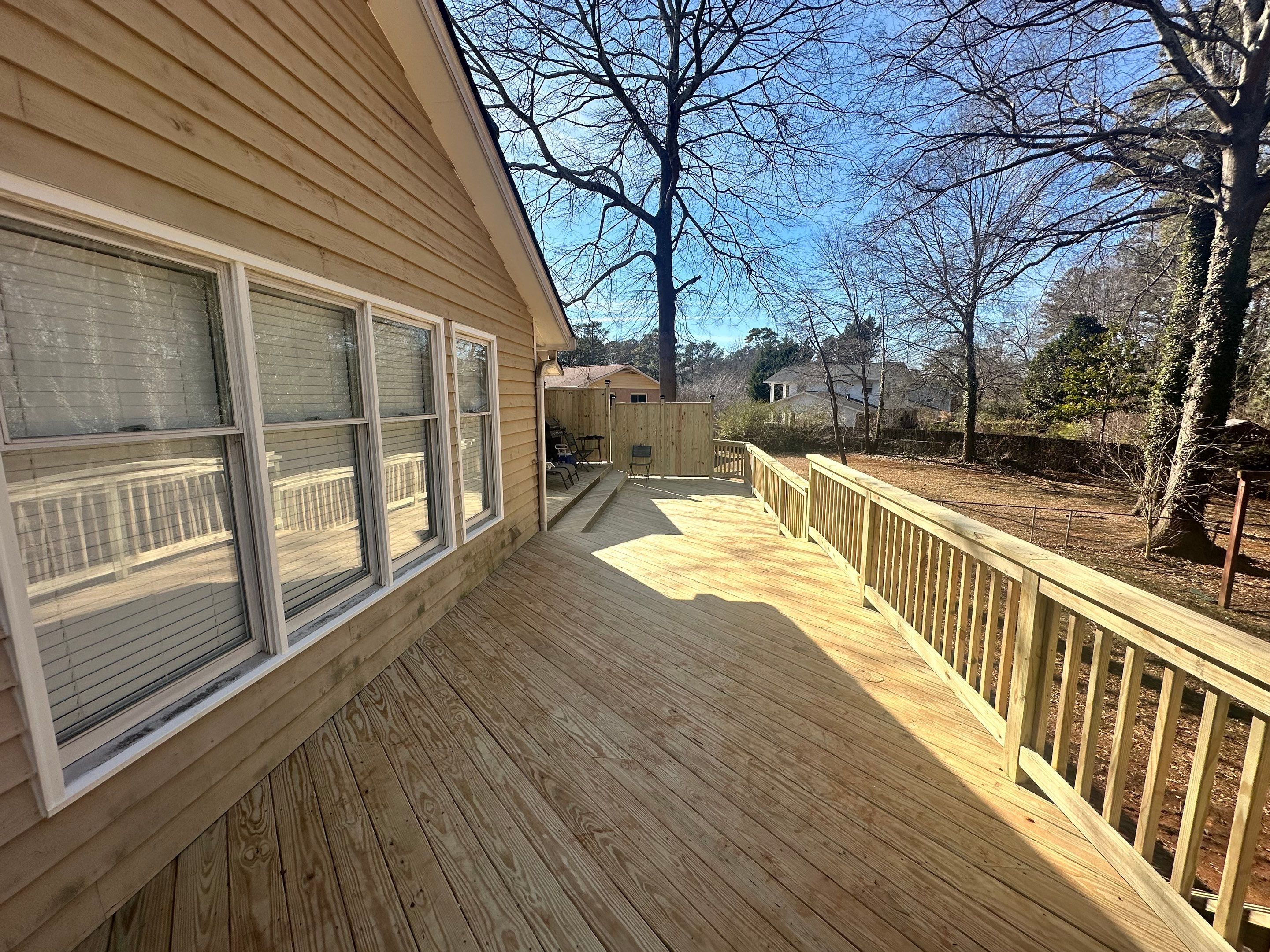 Elevated Pressure-Treated Wood Deck Extension in Marietta by Swift Home Renovations