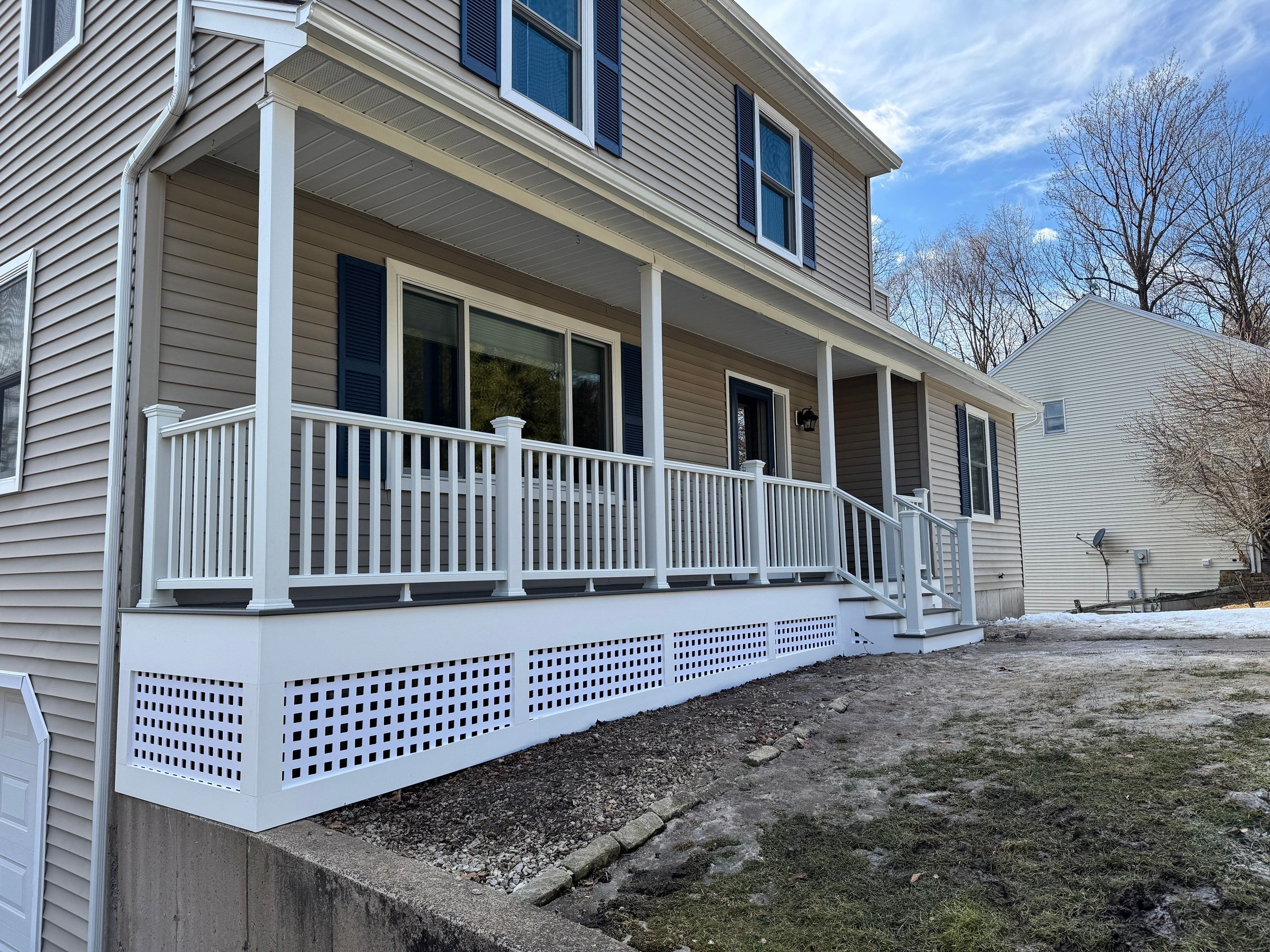 Replacement front porch using Trex Tropical Island mist and White composite railings. Includes lattice bottom. by DiGiorgi Roofing and Siding Inc
