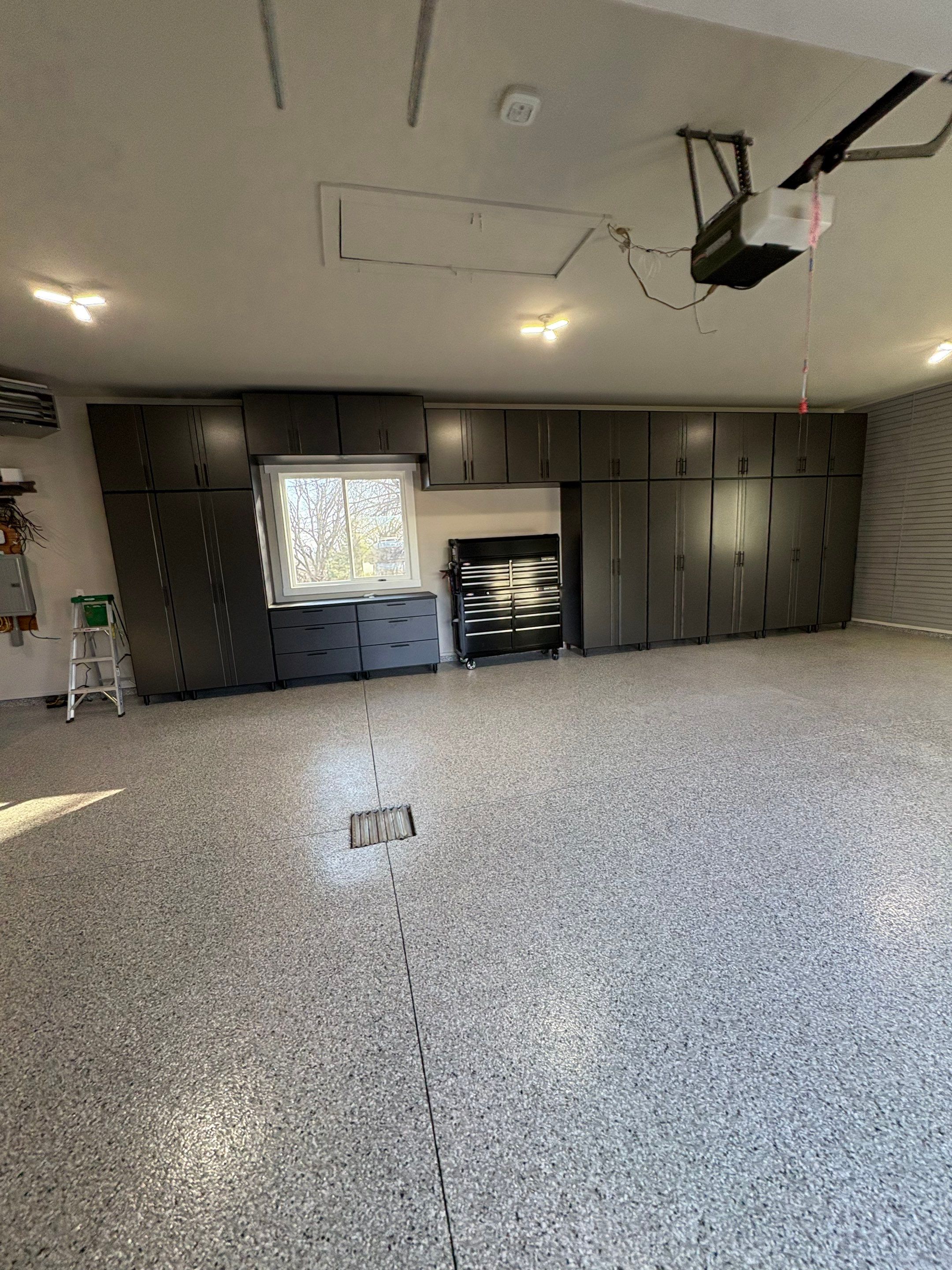 Yankton Garage Transformation with Dark Storage Cabinetry and Epoxy Flooring by Select Painting, Coatings & Garage Cabinets