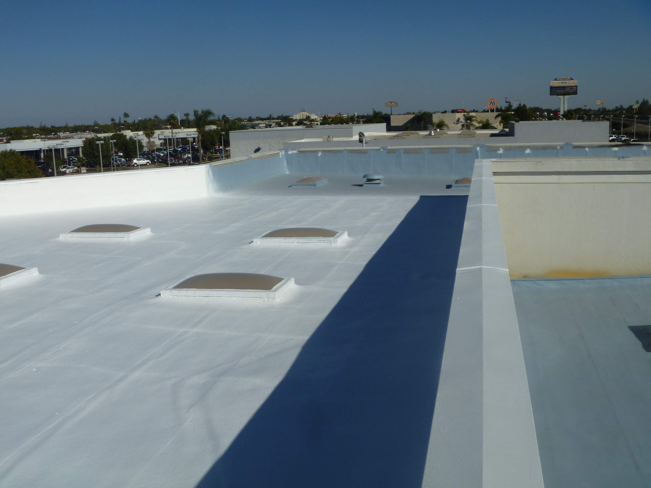 Commercial Roofing Installation using Spray foam and Conklin Benchmark/PUMA XL 18 yr warranty coatings by Straight Edge Roofing Inc