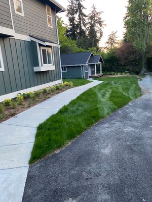 Patio Installation using Concrete, Retaining walls, and Turf install