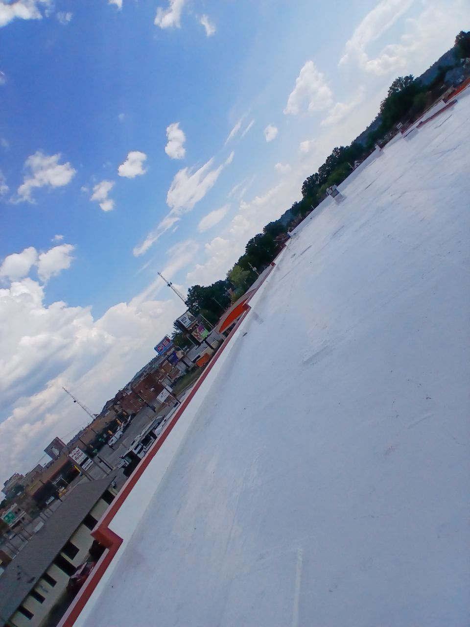 Commercial Roofing Installation using smartcoat Roof coating by Fahey Roofing + Contracting