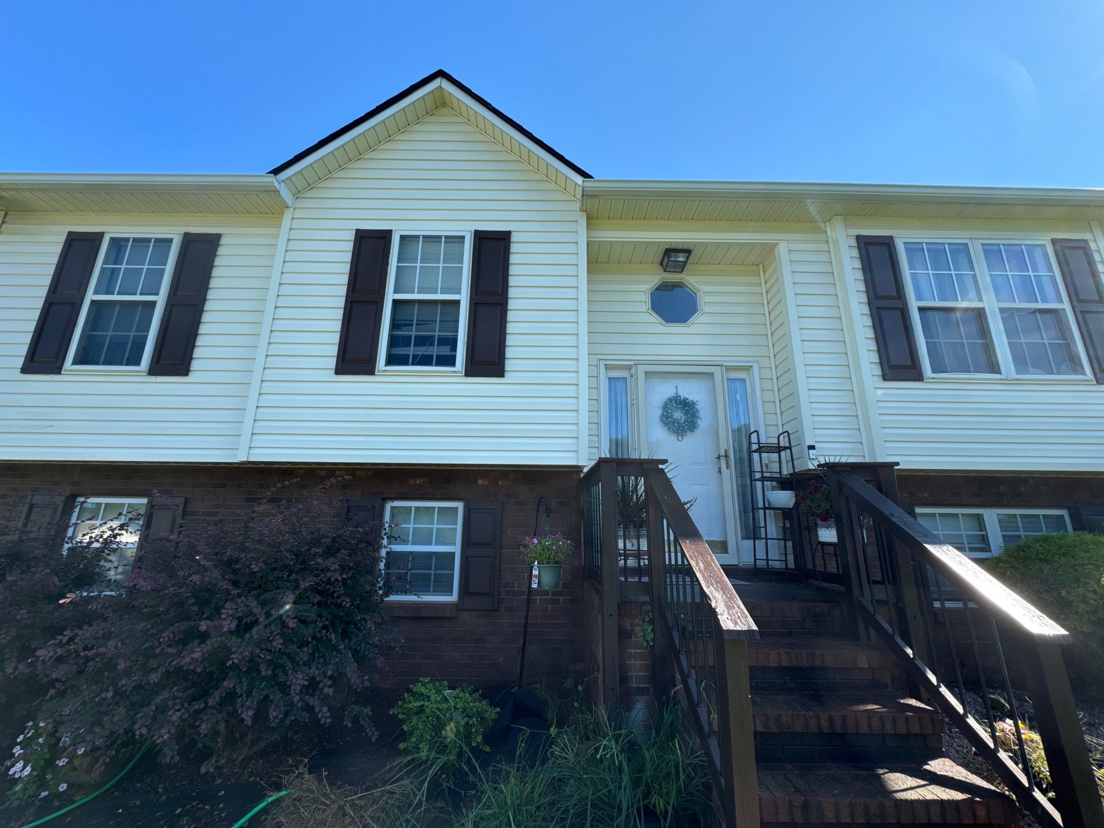 the service being done is cleaning the siding and front steps of the house to remove dirt and debris