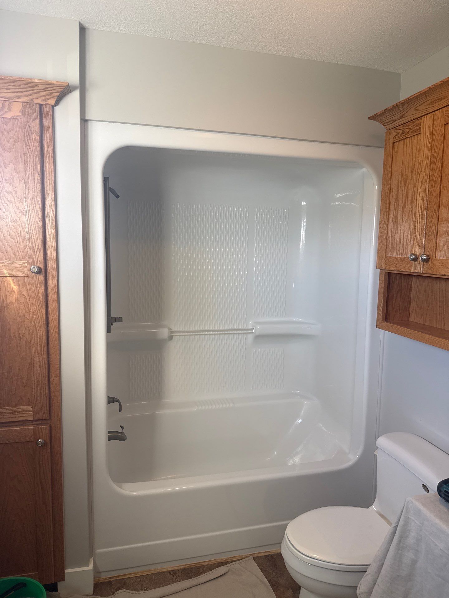 White Acrylic Bathtub and Frosted Glass Shower Door Installation in Beulah by Rainbow Seamless Systems