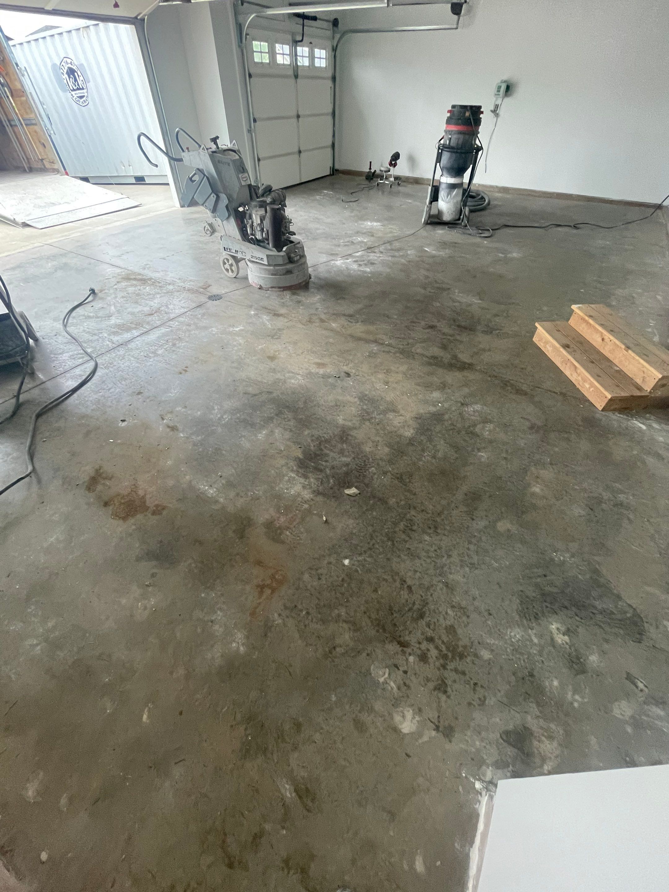 Grey Flake Epoxy Garage Floor Coating in Sioux Falls by Select Painting, Coatings & Garage Cabinets